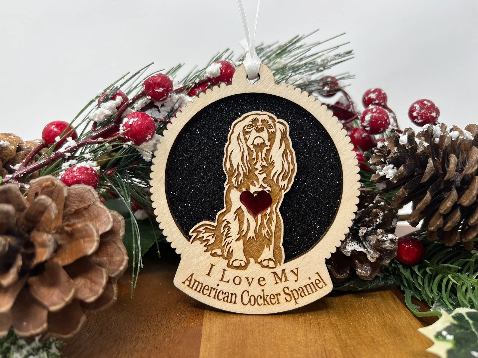 A beautifully crafted wooden ornament featuring a silhouette of an American Cocker Spaniel, perfect for Christmas decoration.