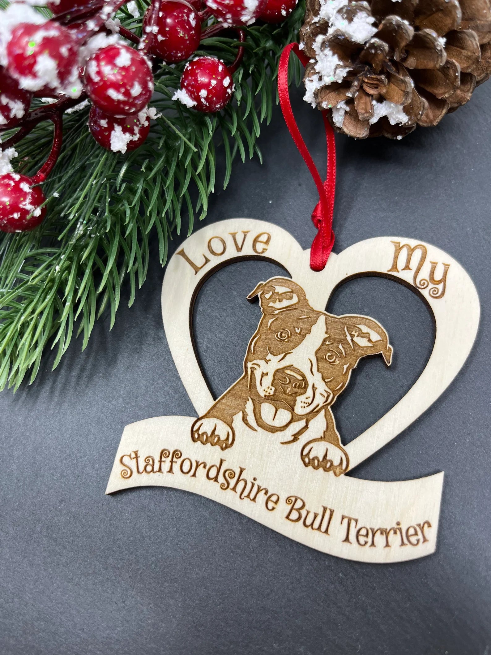 Laser engraved wooden ornament featuring an American Staffordshire design, perfect for Christmas decoration.