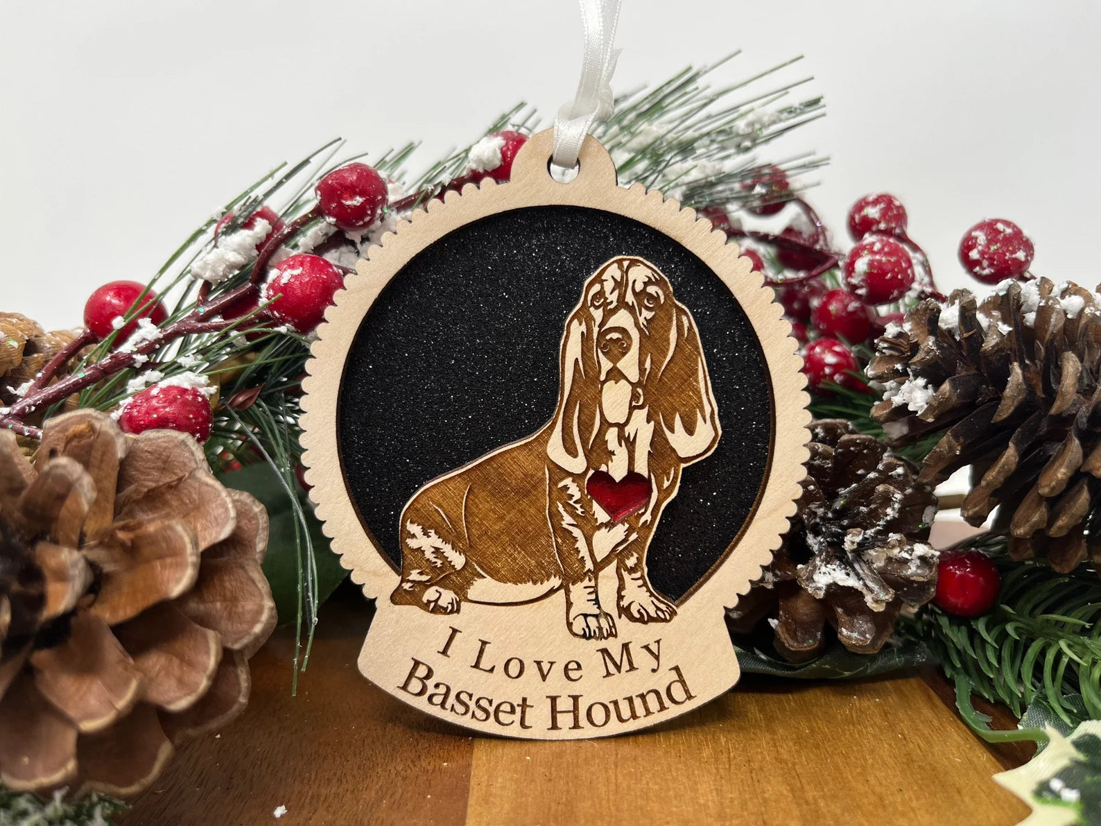 A beautifully crafted wooden ornament featuring a silhouette of a Basset Hound, perfect for Christmas decoration.