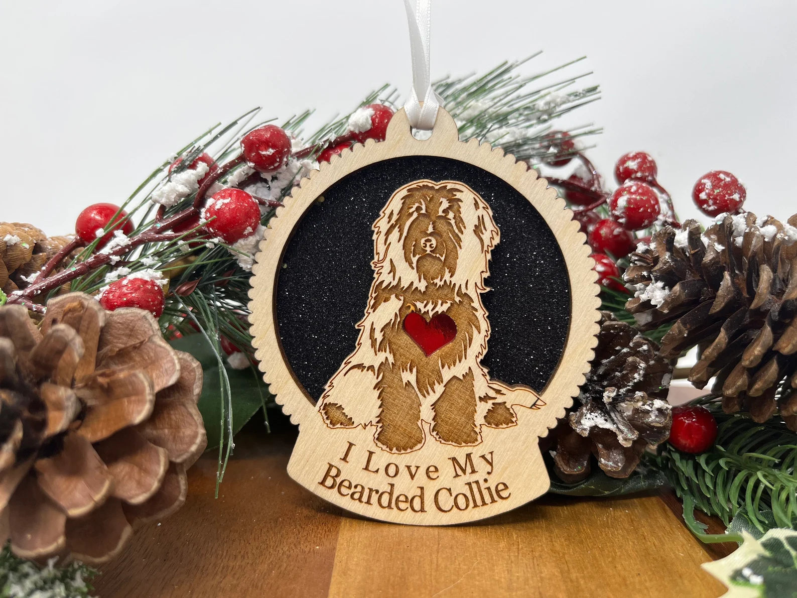 A beautifully crafted wooden ornament featuring a Bearded Collie silhouette, perfect for holiday decor.