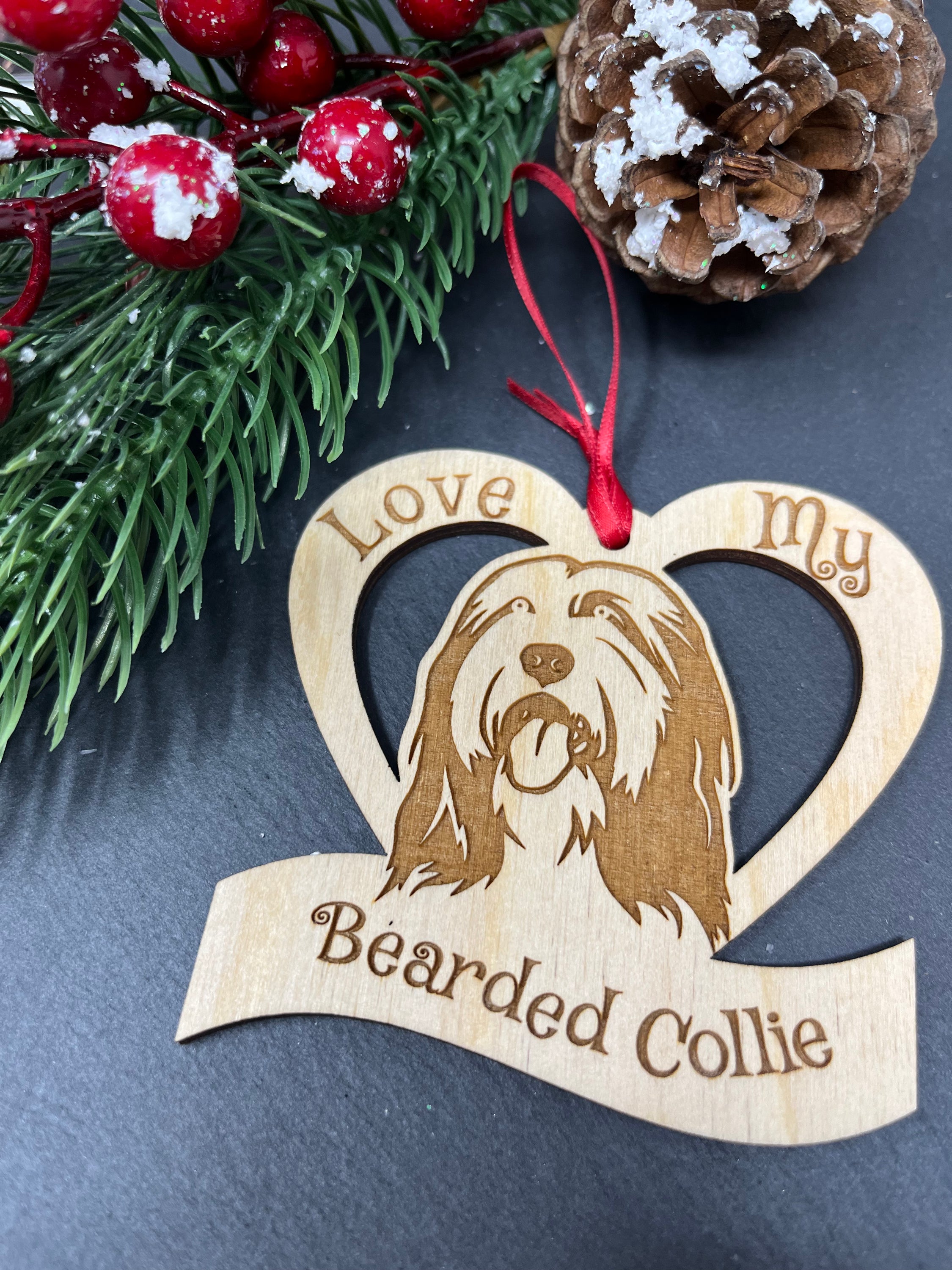 Laser engraved wooden ornament featuring a Bearded Collie, perfect for Christmas decoration.