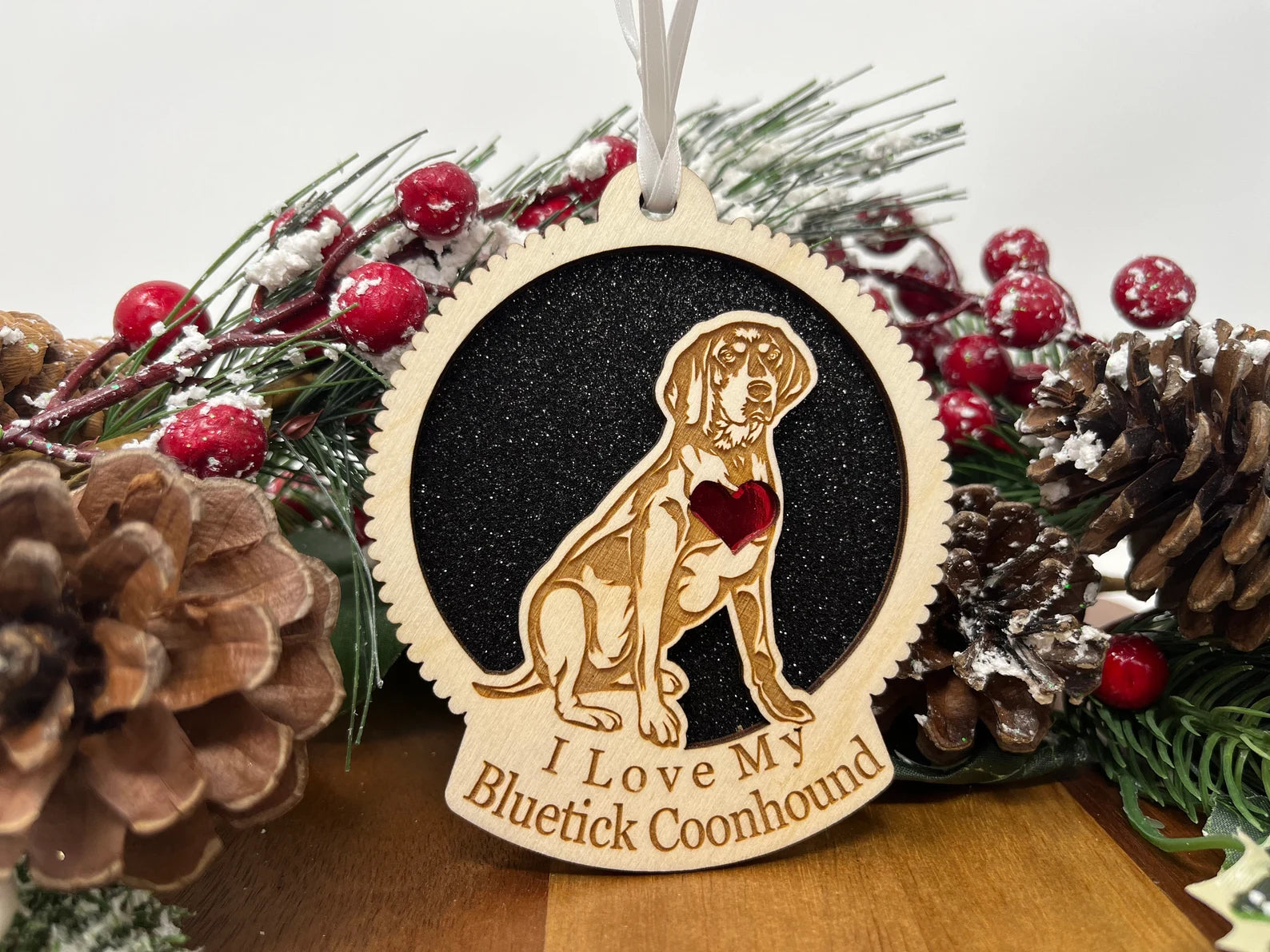 A beautifully crafted laser cut wooden ornament featuring a Bluetick Coonhound silhouette, perfect for Christmas decoration.