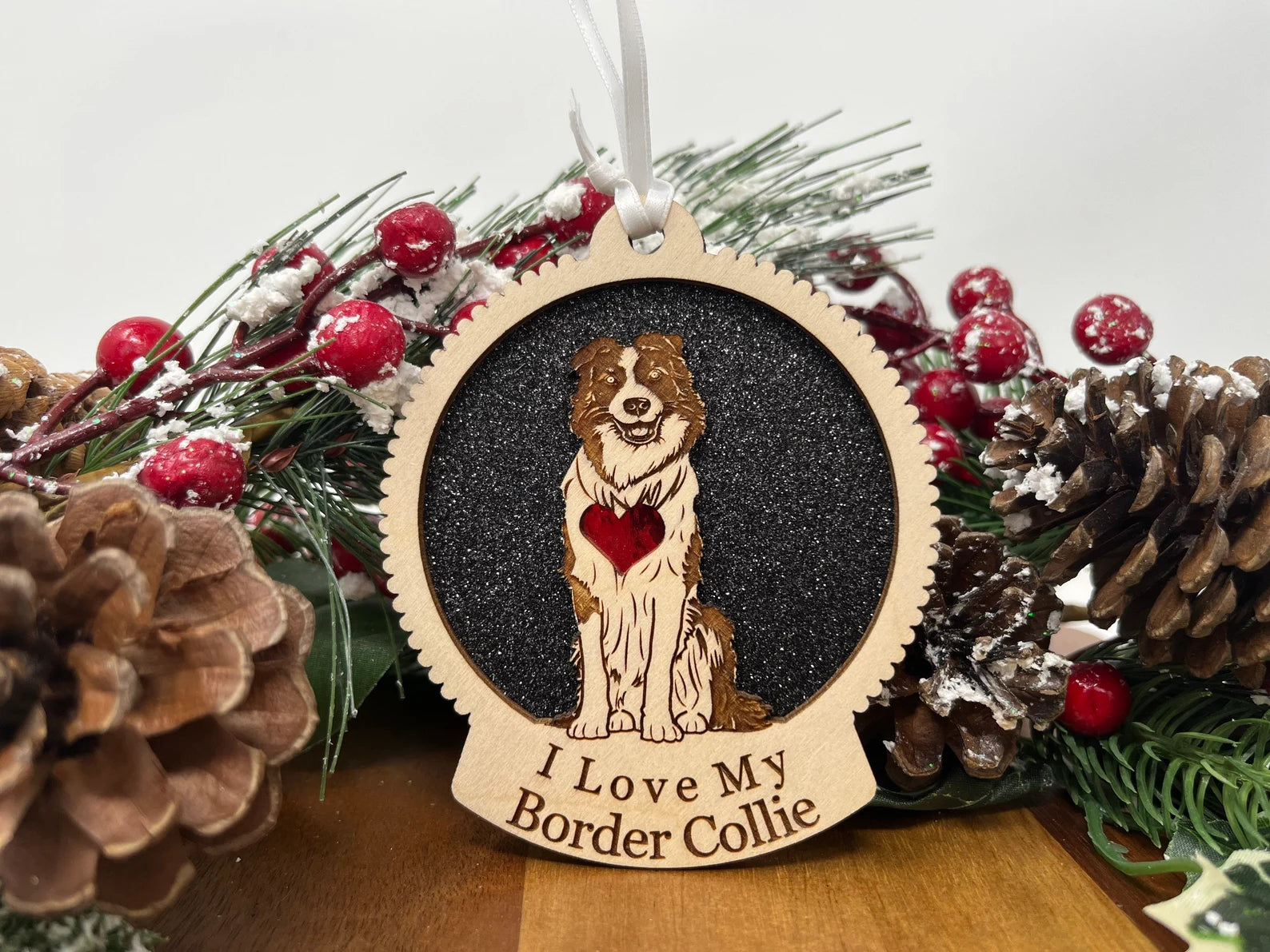 A beautifully crafted Love My Border Collie ornament made from laser-cut Baltic Birch wood, featuring a silhouette of a Border Collie, ready to hang with a ribbon.