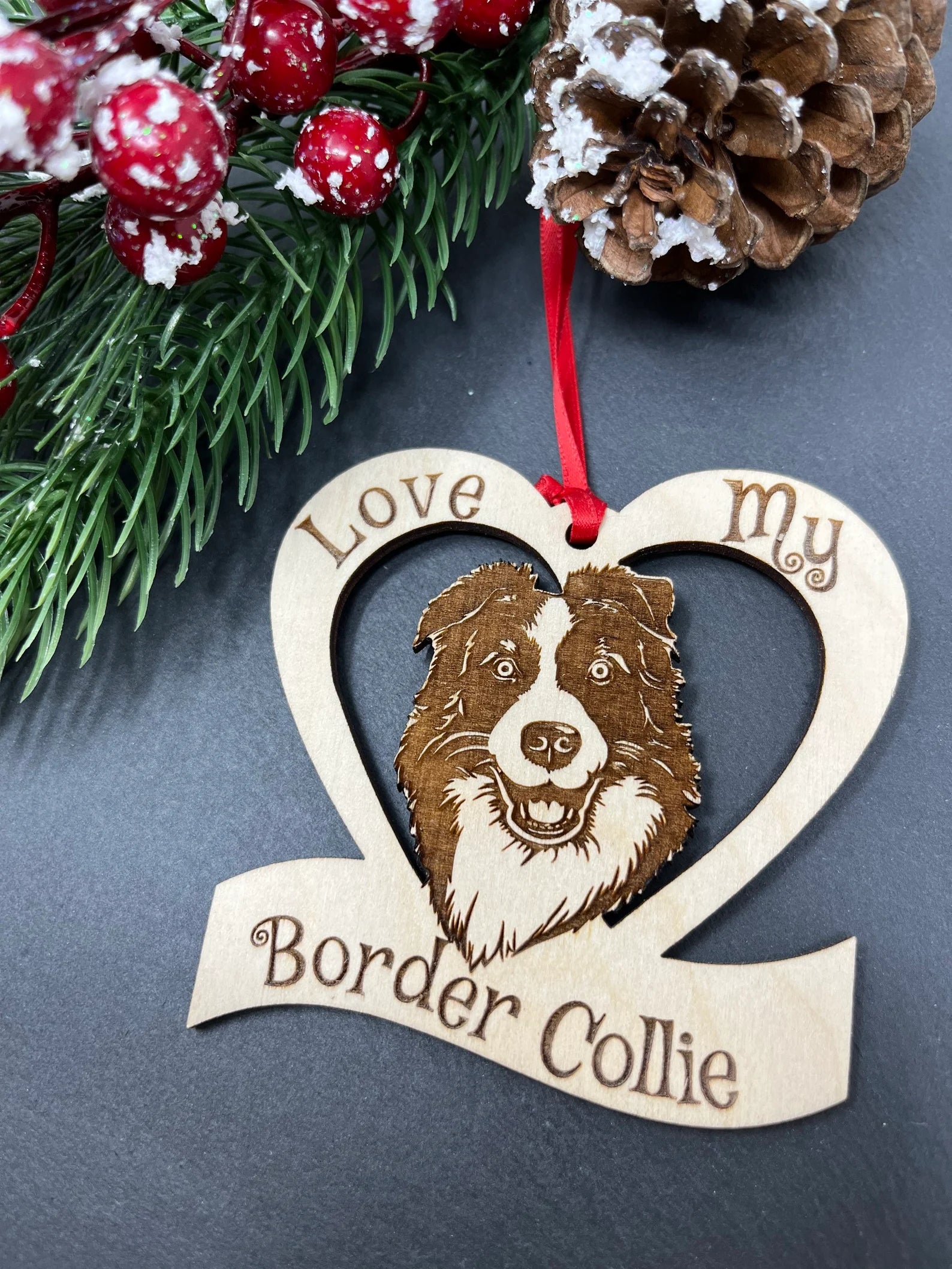 A beautifully laser engraved wooden ornament featuring a Border Collie design, perfect for Christmas decoration.