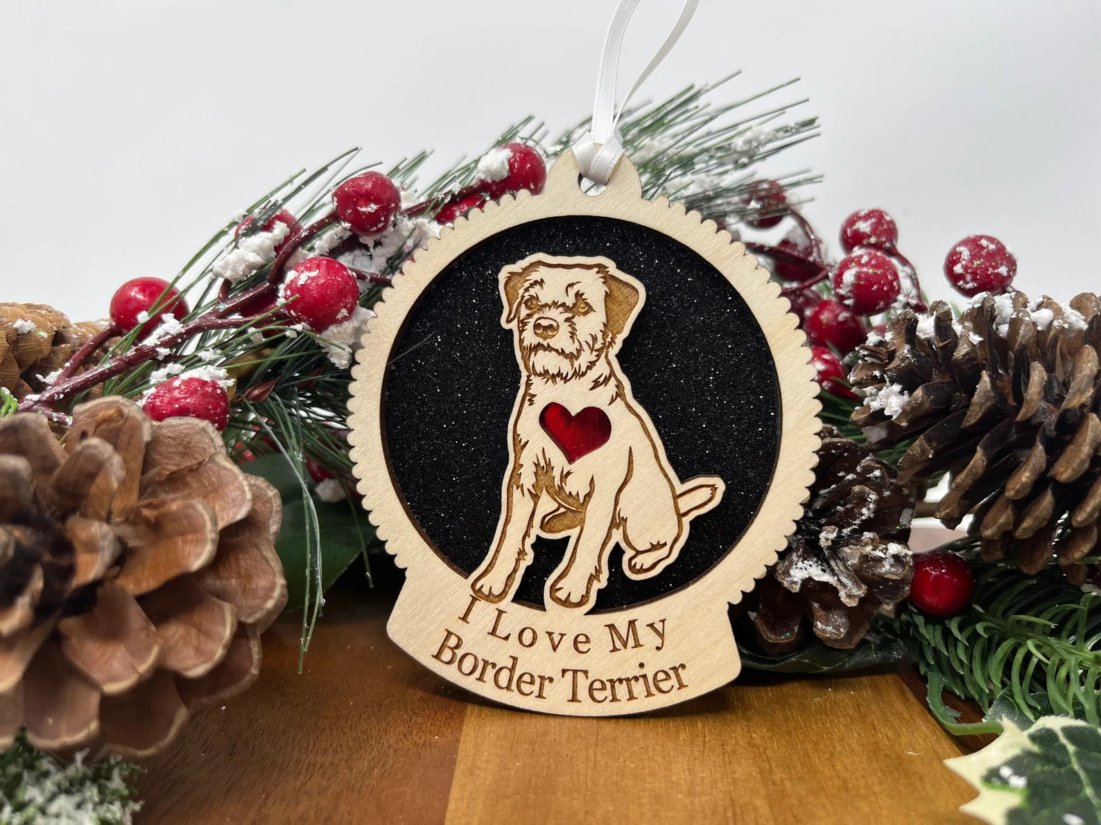 Love My Border Terrier ornament made of laser-cut Baltic Birch wood, featuring a detailed silhouette of a Border Terrier, ready to hang with a ribbon.