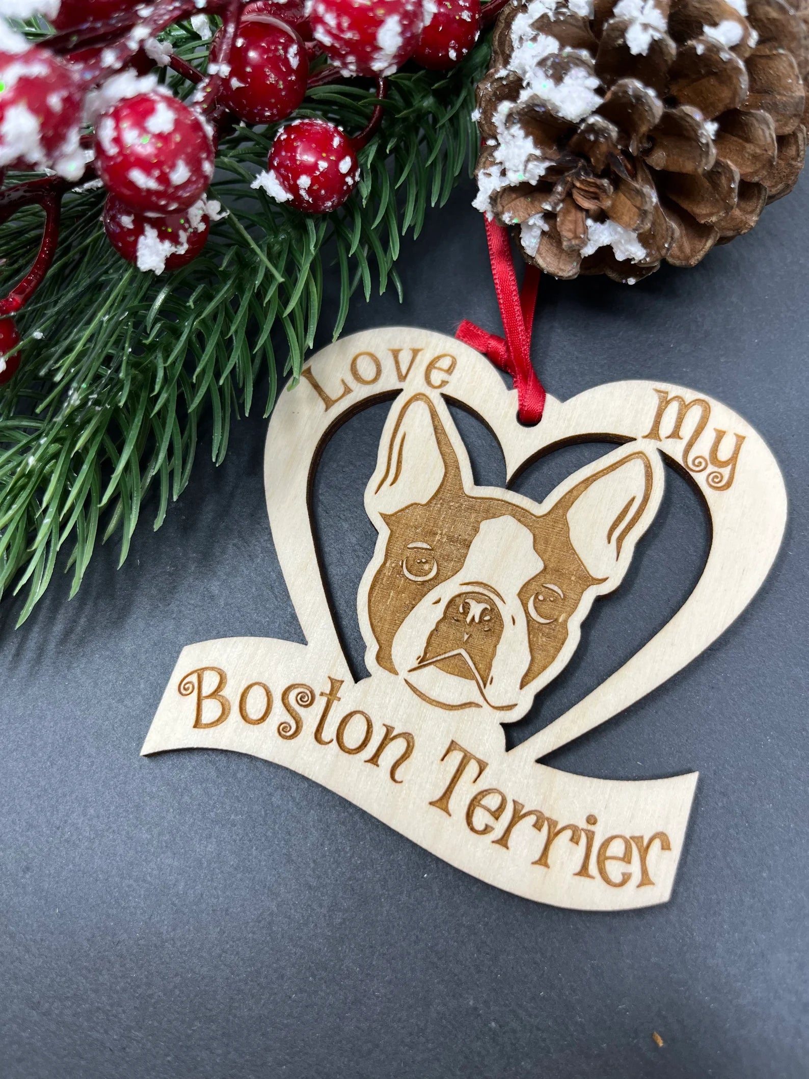 Love My Boston Terrier ornament made of laser engraved Baltic Birch wood, featuring a unique design and attached ribbon for hanging.