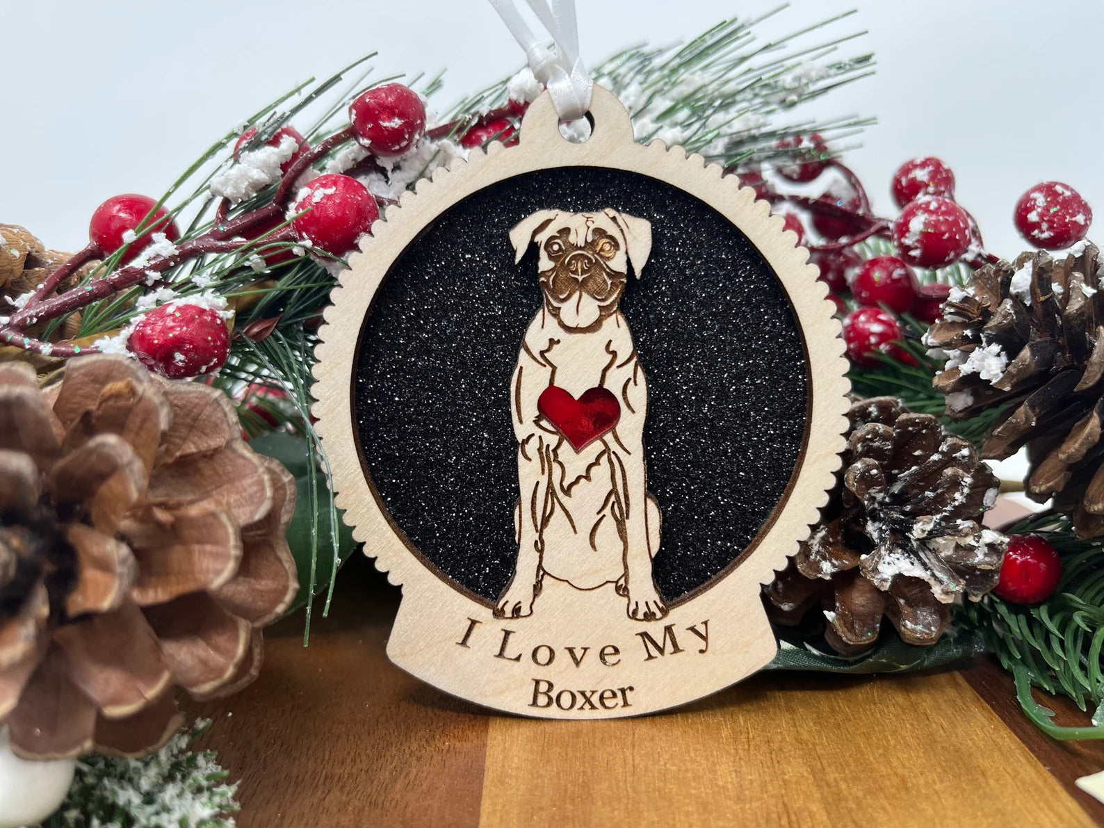 A beautifully crafted laser-cut wooden ornament featuring a boxer dog silhouette, perfect for Christmas decoration.