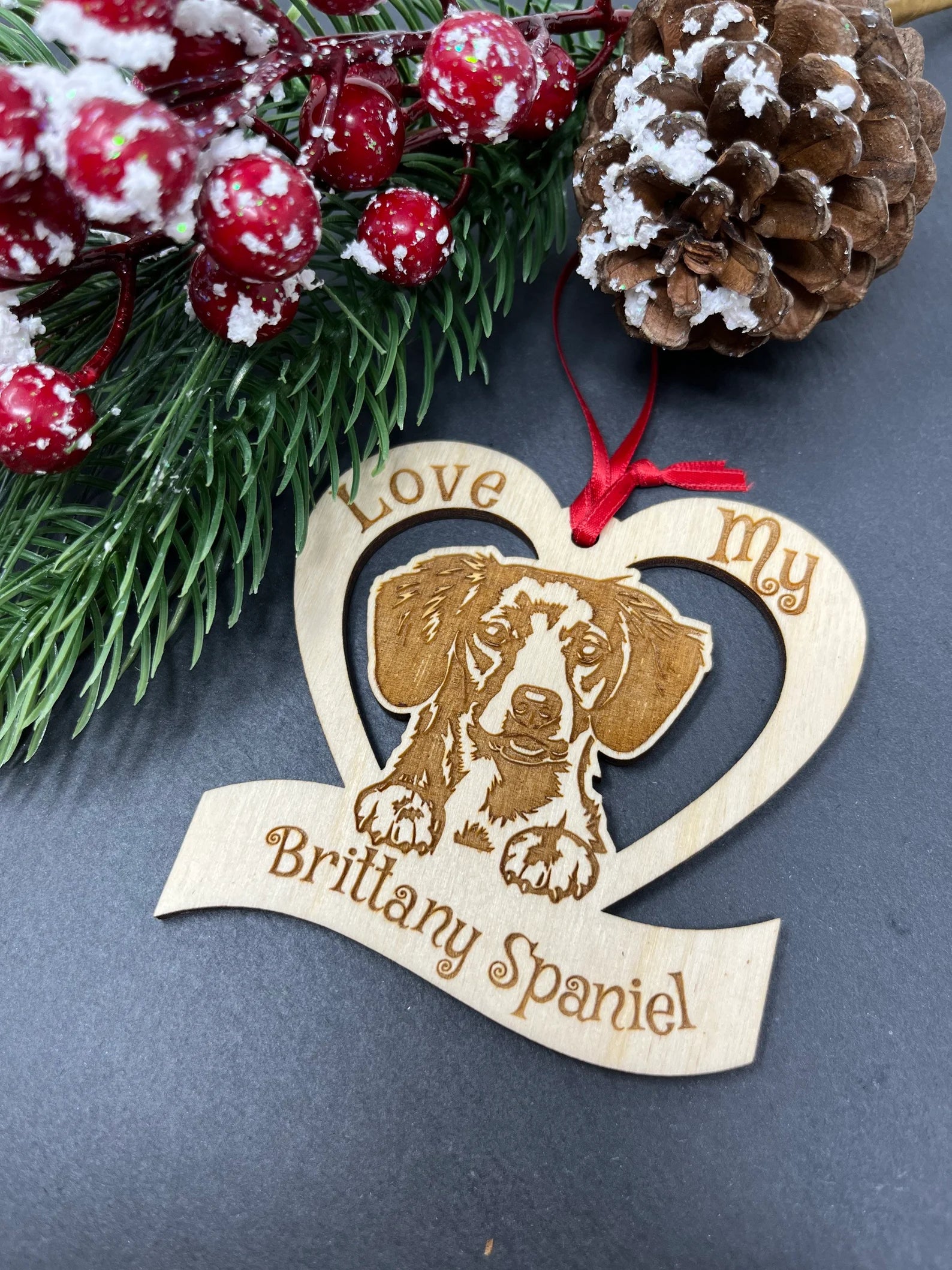 Laser engraved wooden ornament featuring a Brittany Spaniel, perfect for Christmas decoration.