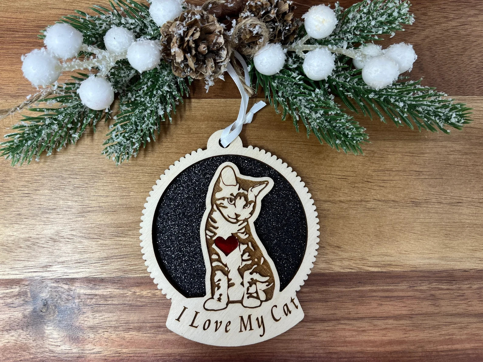 A beautifully crafted laser-cut wooden ornament featuring a cat silhouette, perfect for Christmas or as a collectible item.