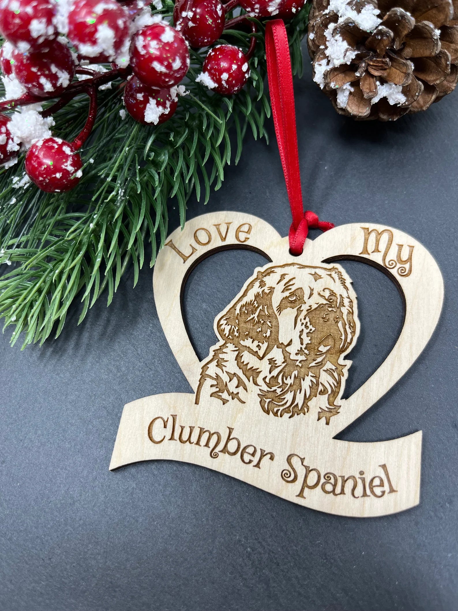 Laser engraved wooden ornament featuring a Clumber Spaniel design, perfect for Christmas decoration.