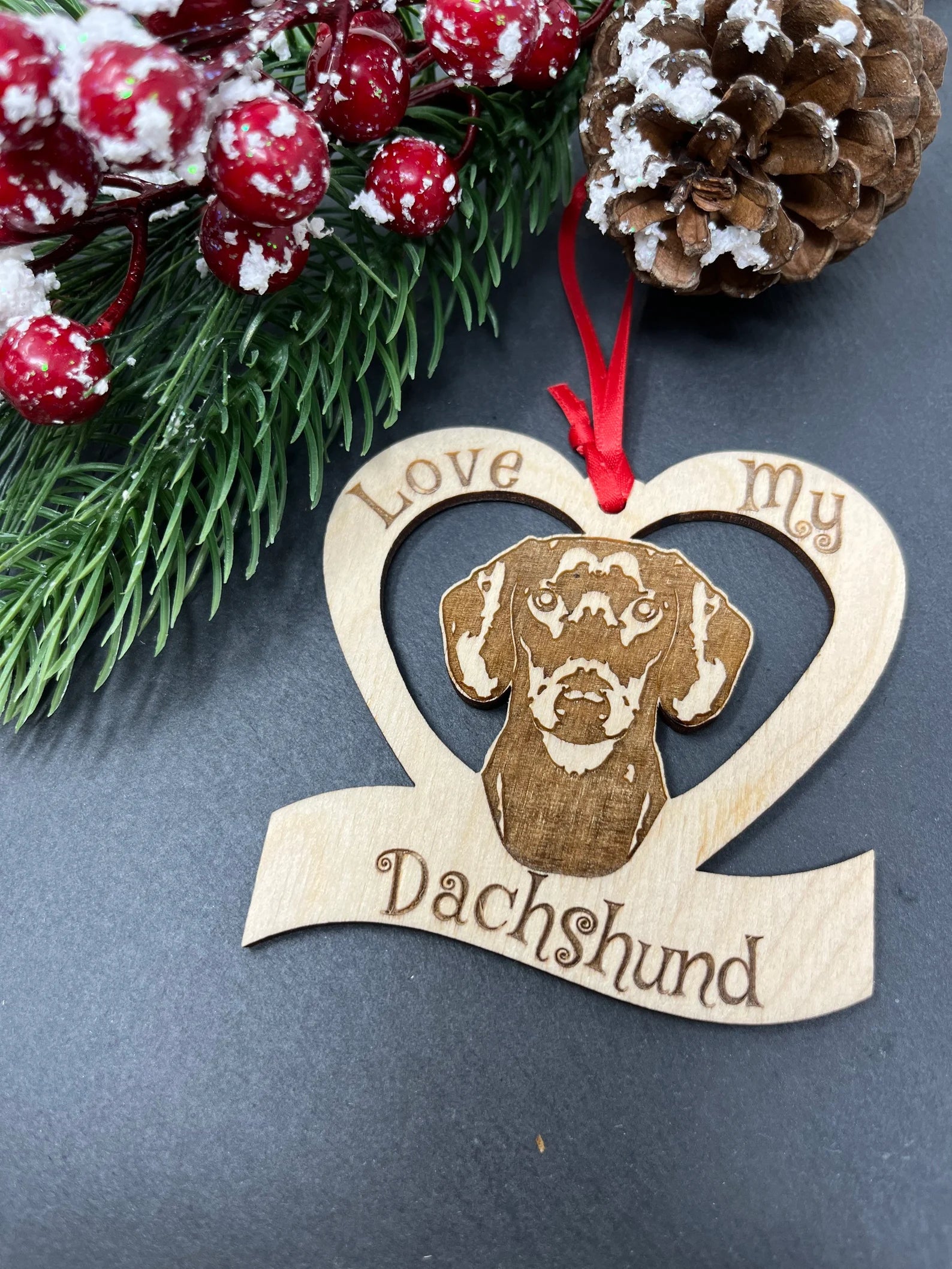 Laser engraved wooden ornament featuring a dachshund, perfect for Christmas decoration.