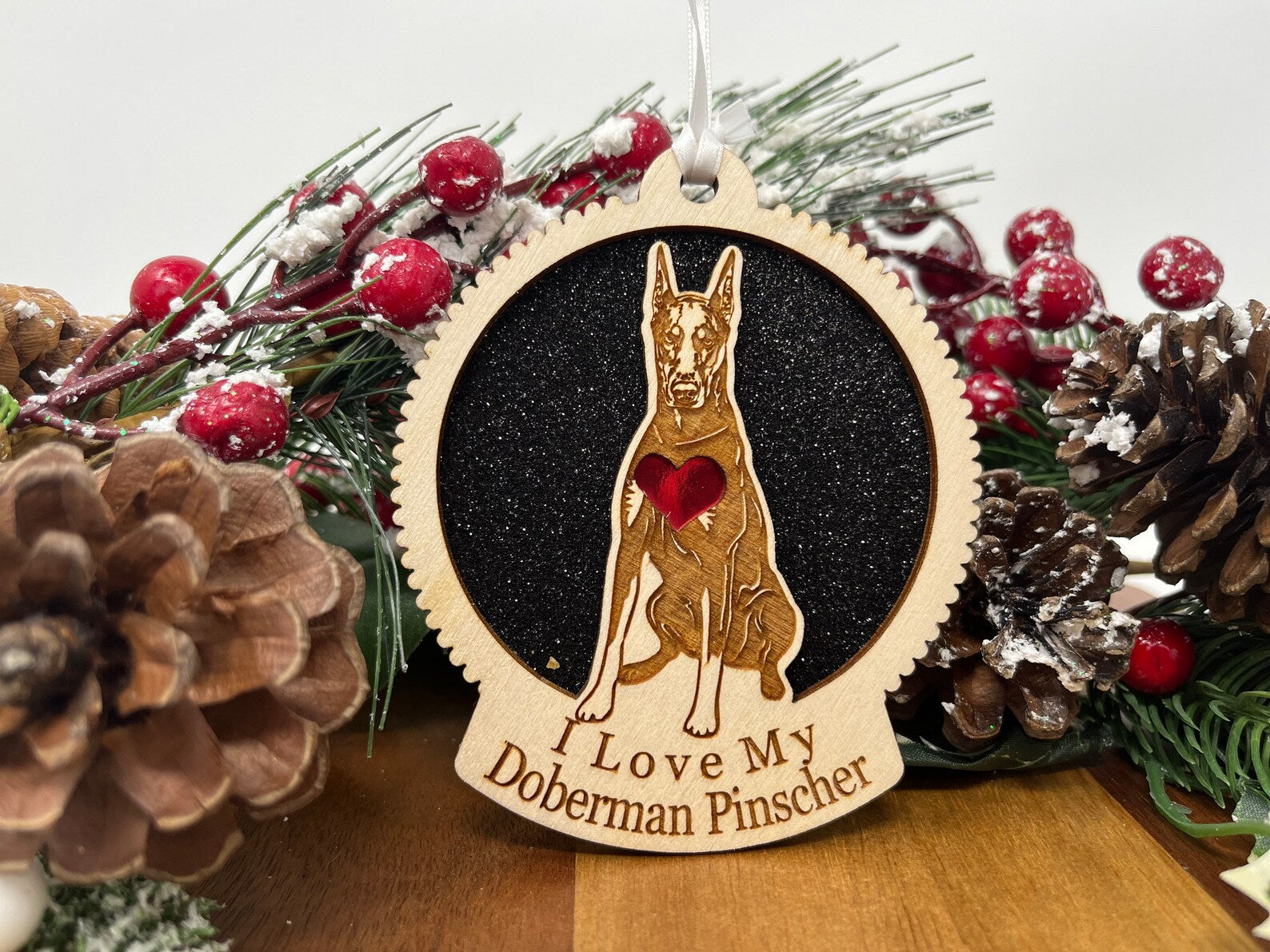 A beautifully crafted laser-cut wooden ornament featuring a Doberman silhouette, perfect for Christmas decoration.