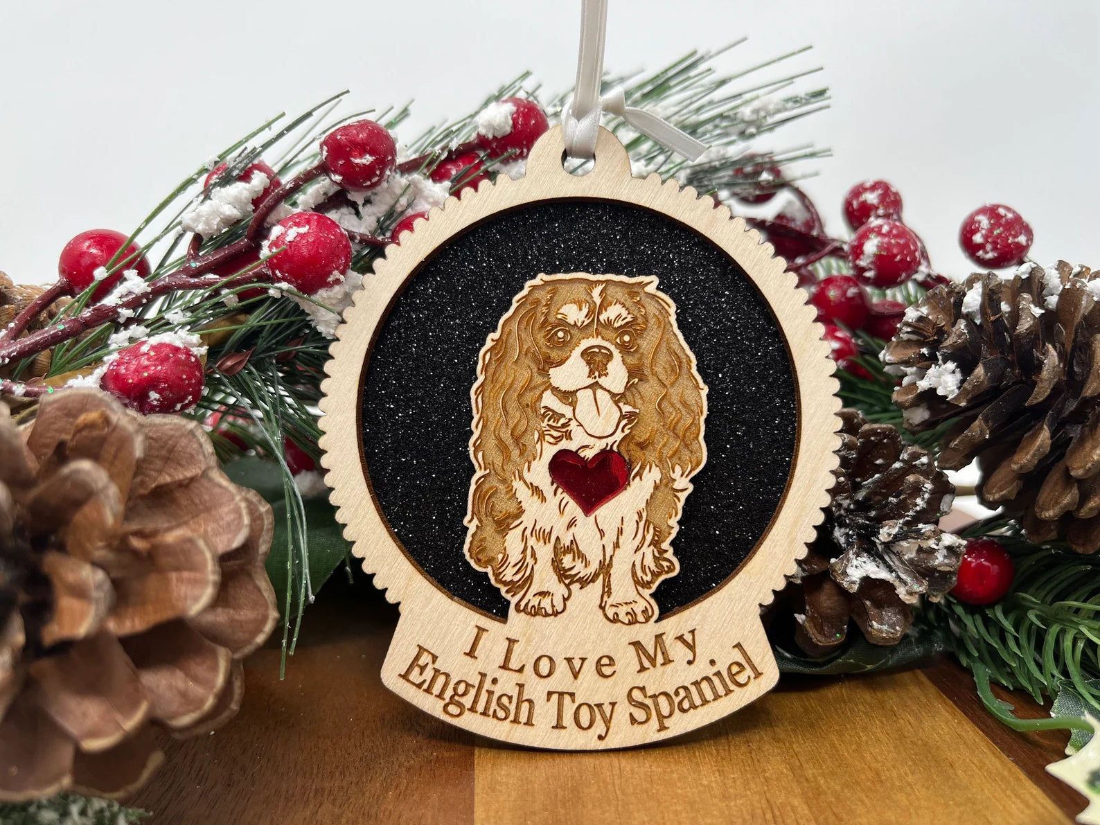 Laser cut wooden ornament featuring an English Toy Spaniel silhouette, perfect for Christmas decoration.