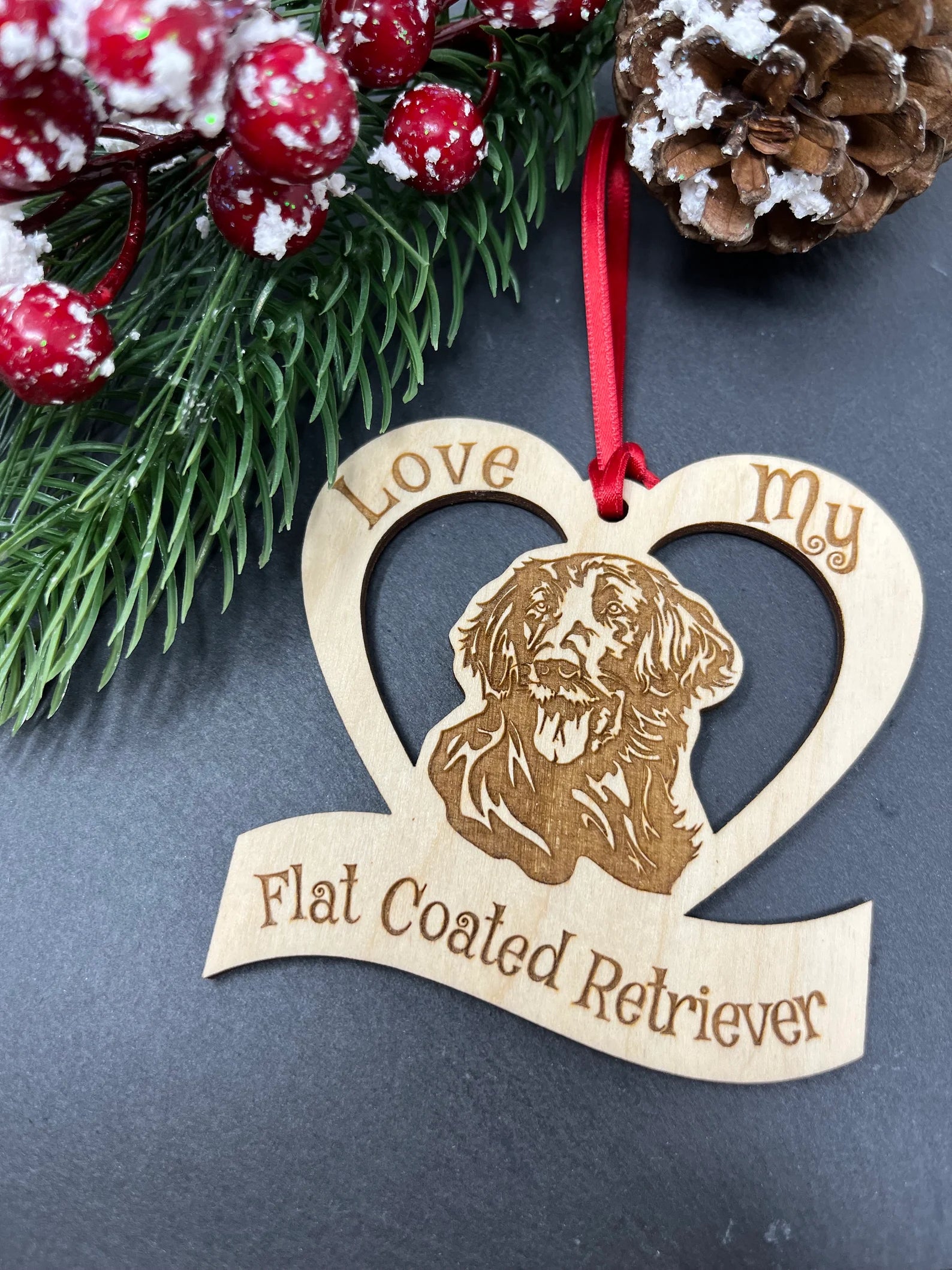 Laser engraved wooden ornament featuring a Flat Coated Retriever, perfect for Christmas decoration.