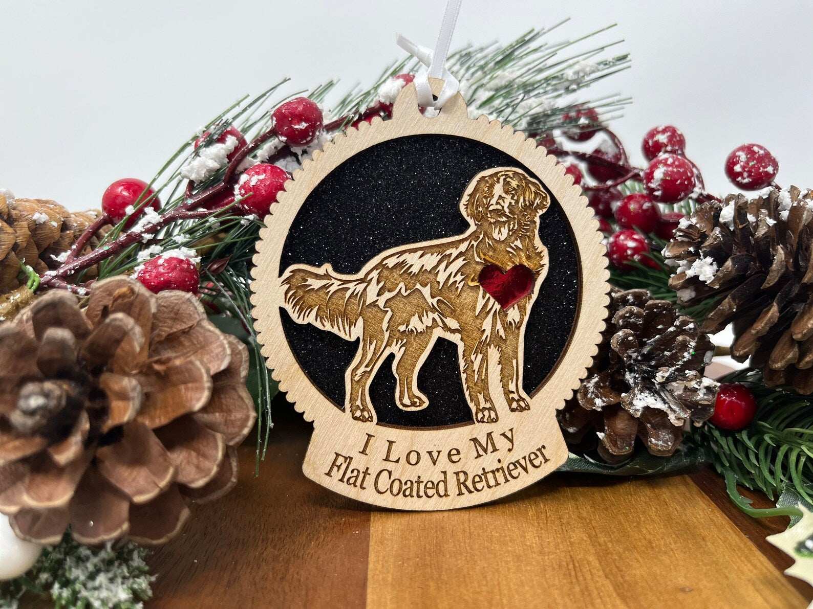 Laser cut wooden ornament featuring a Flat Coated Retriever silhouette, perfect for holiday decor.