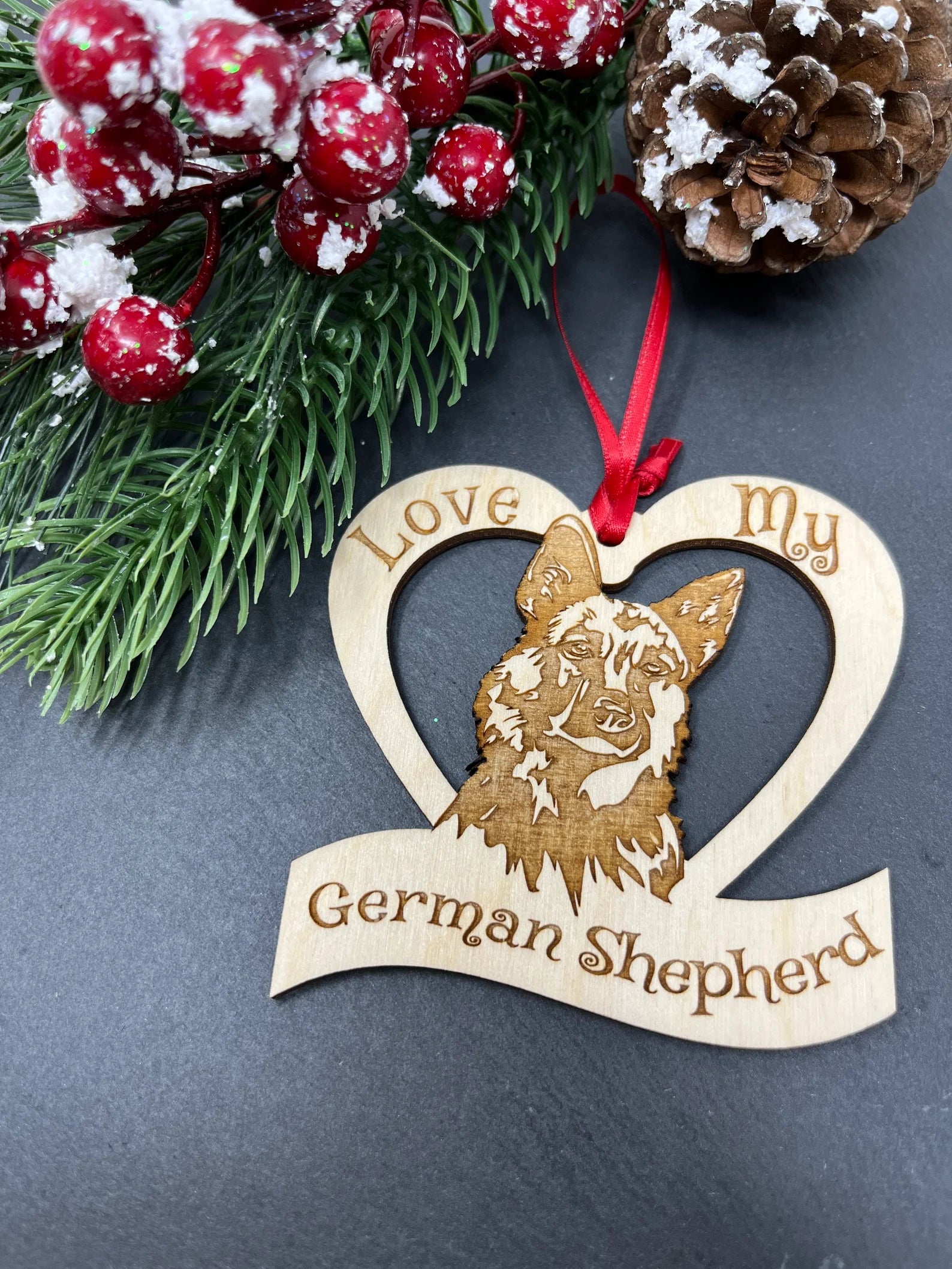 Laser engraved wooden ornament featuring a German Shepherd design, perfect for Christmas decoration.