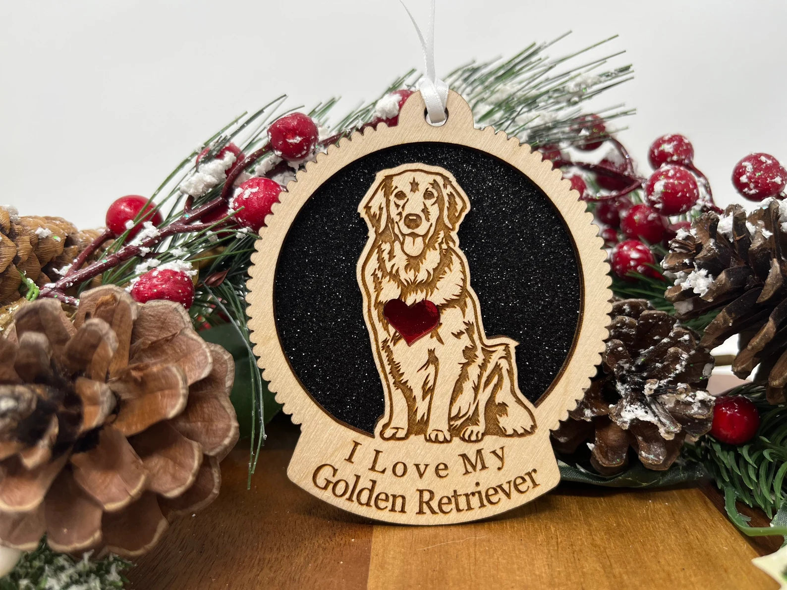 A beautifully crafted laser-cut wooden ornament featuring a silhouette of a Golden Retriever, perfect for Christmas decoration.