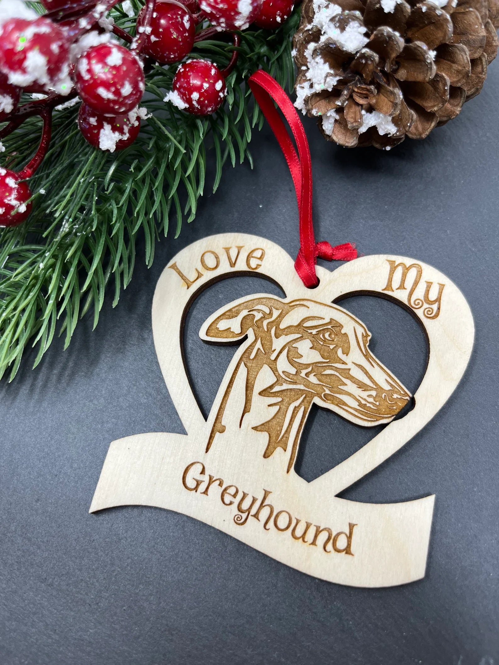 Love My Greyhound ornament made of laser engraved Baltic Birch wood, featuring a unique design, ready to hang with a ribbon.