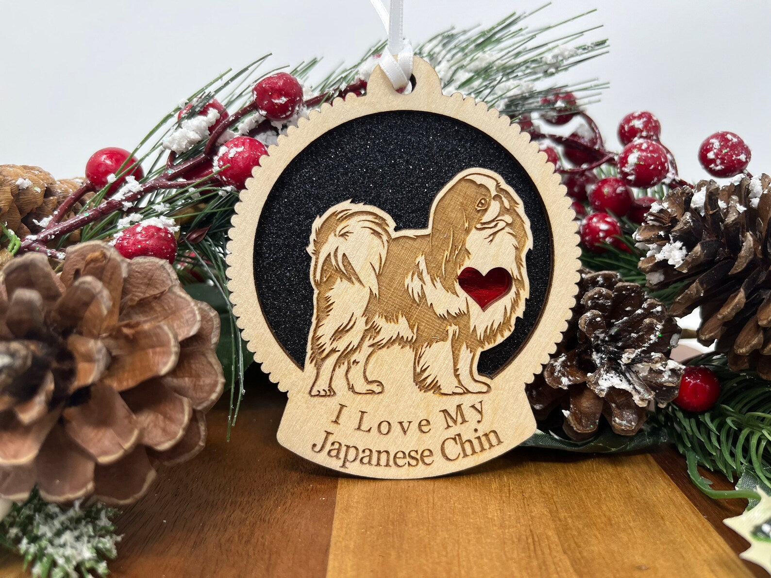 Laser cut wooden ornament featuring a Japanese Chin silhouette, perfect for Christmas decoration.