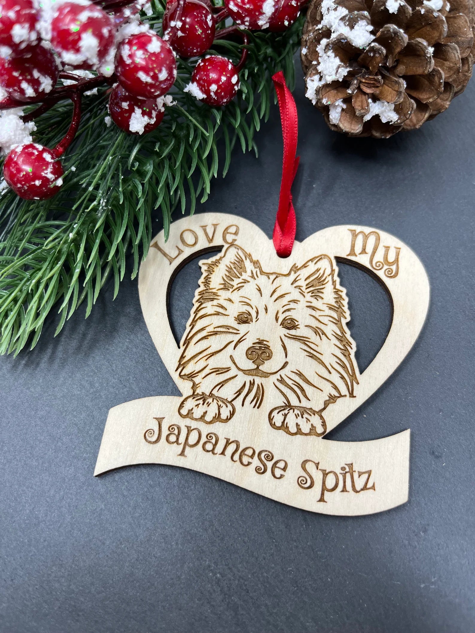 Laser engraved wooden ornament featuring a Japanese Spitz, perfect for Christmas decoration.