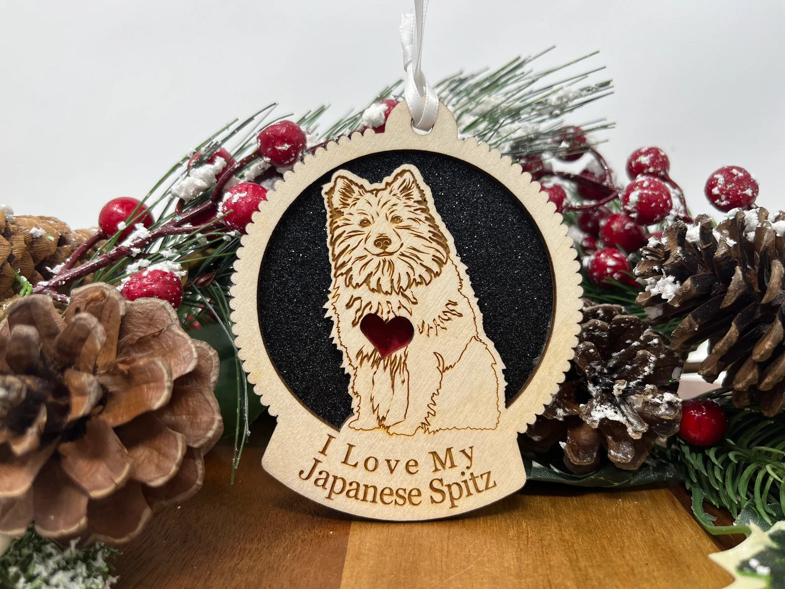 A beautifully crafted wooden ornament featuring a silhouette of a Japanese Spitz, perfect for Christmas decoration.