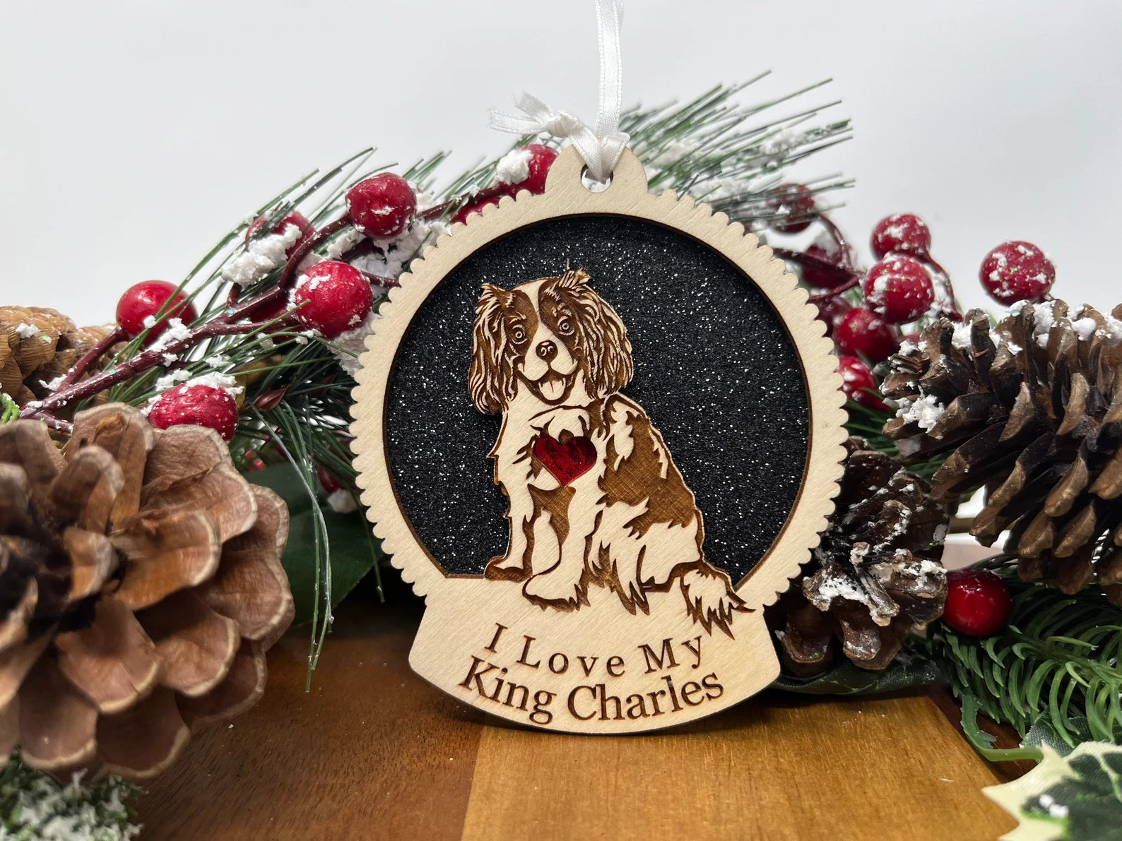 Laser cut wooden ornament featuring a King Charles Spaniel silhouette, perfect for Christmas decorations.