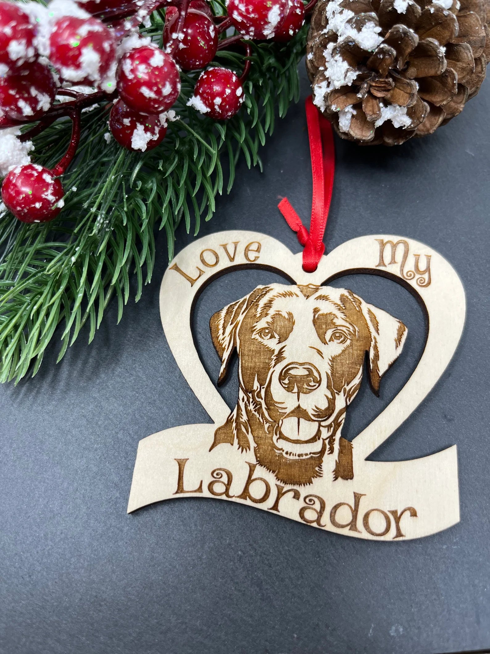 Laser engraved wooden ornament featuring a Labrador design, perfect for Christmas decoration.