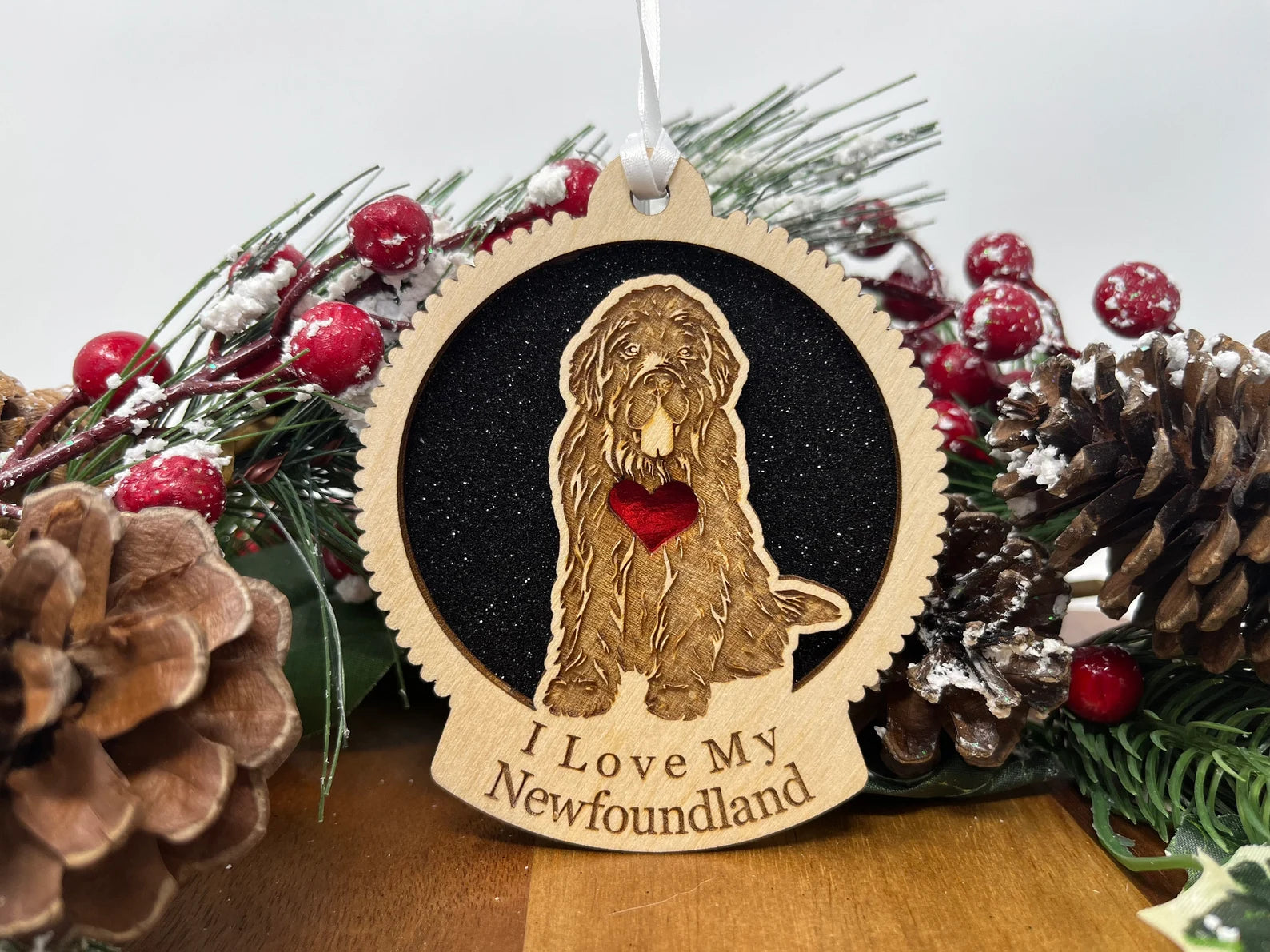 A beautifully crafted wooden ornament featuring a Newfoundland dog silhouette, perfect for Christmas decoration.