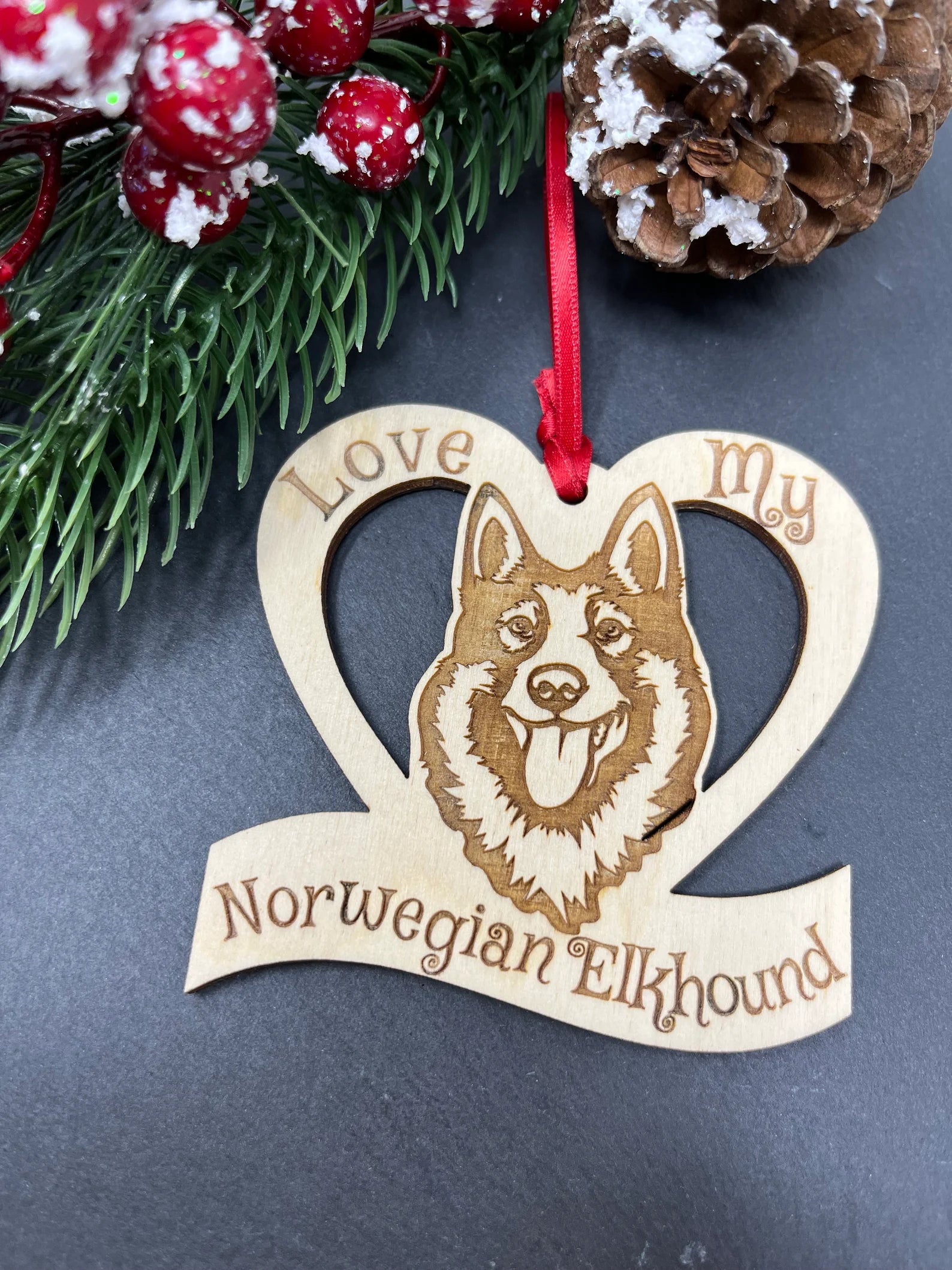 Beautiful laser engraved wooden ornament featuring a Norwegian Elkhound, perfect for Christmas decoration.