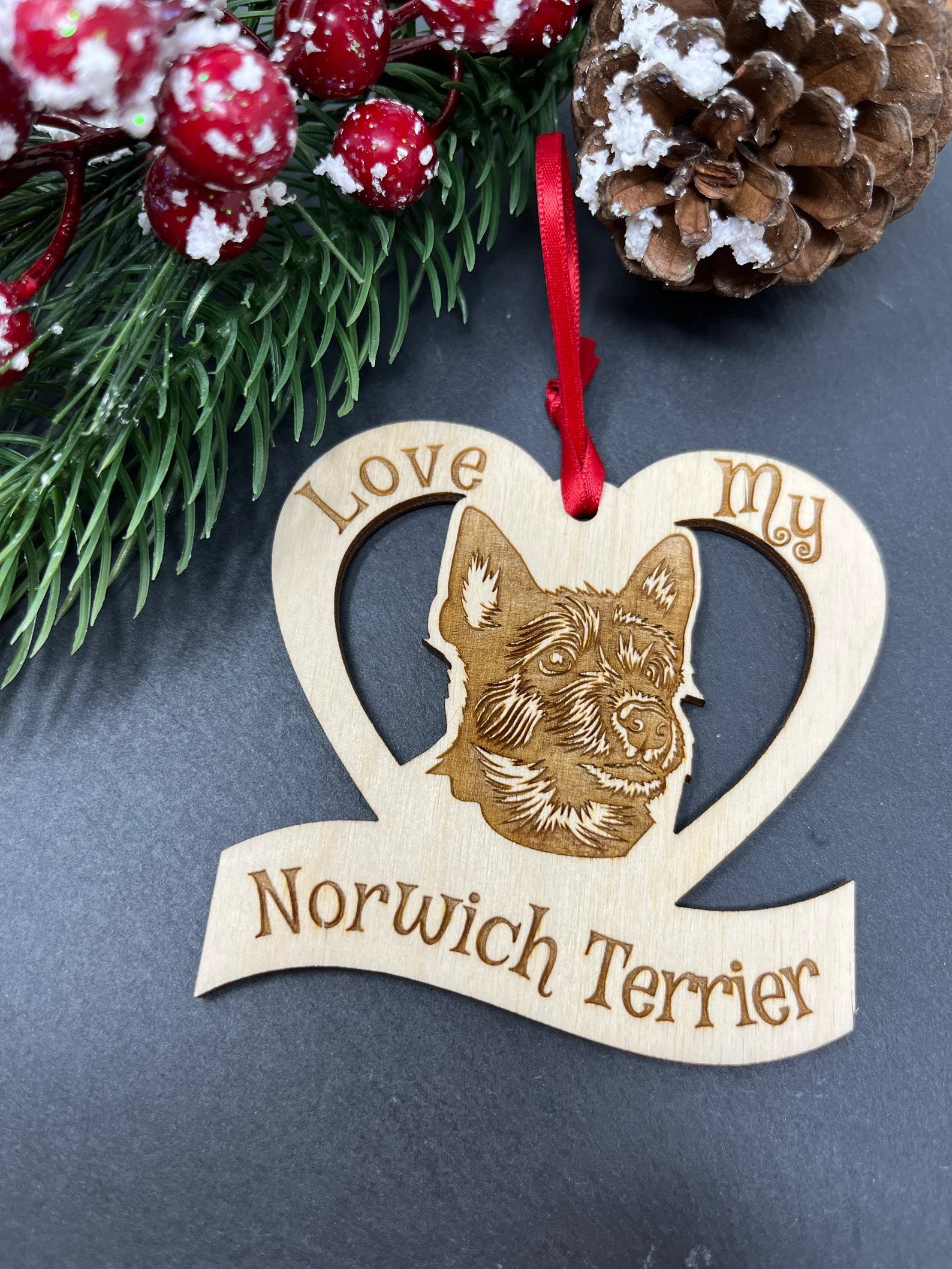 Laser engraved wooden ornament featuring a Norwich Terrier, perfect for Christmas decoration.