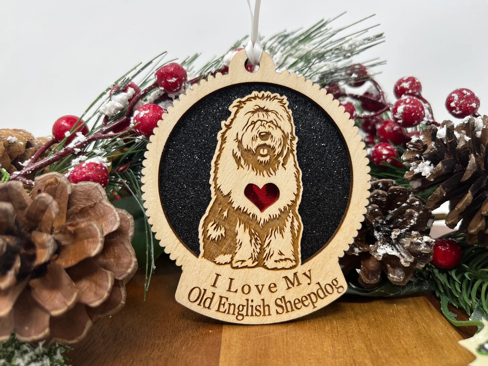 Laser cut wooden ornament featuring an Old English Sheepdog silhouette, perfect for Christmas decoration.