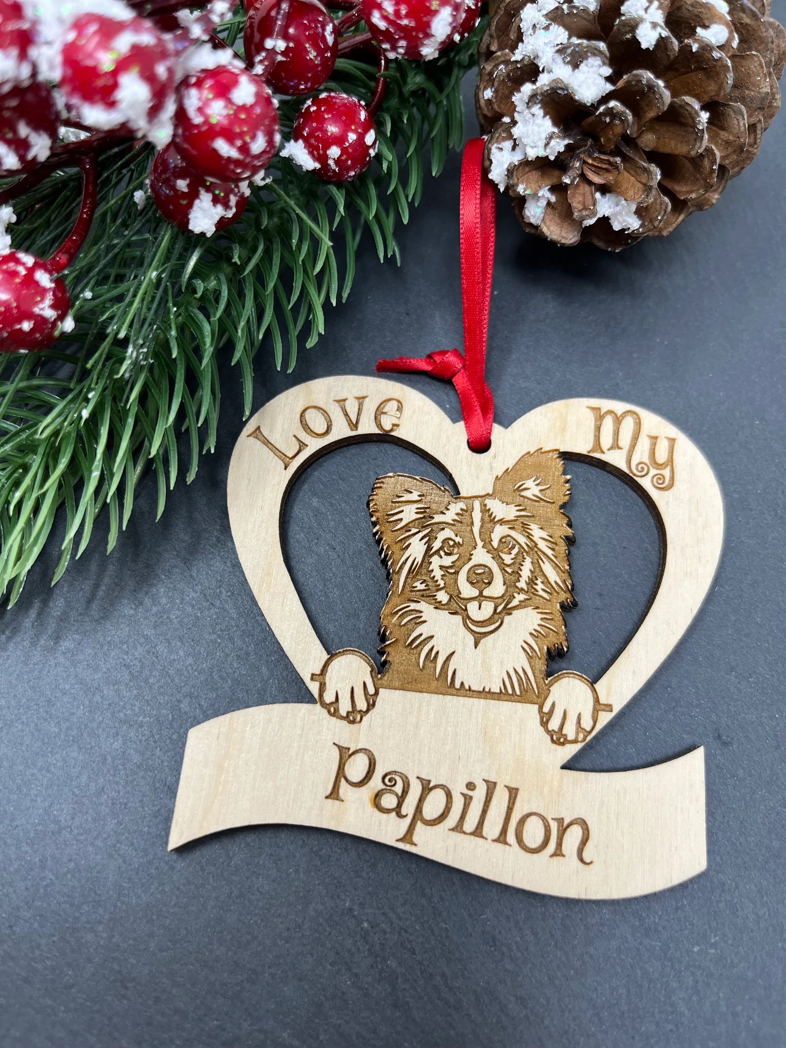 Beautiful laser engraved wooden ornament featuring a Papillon dog, perfect for Christmas decoration.