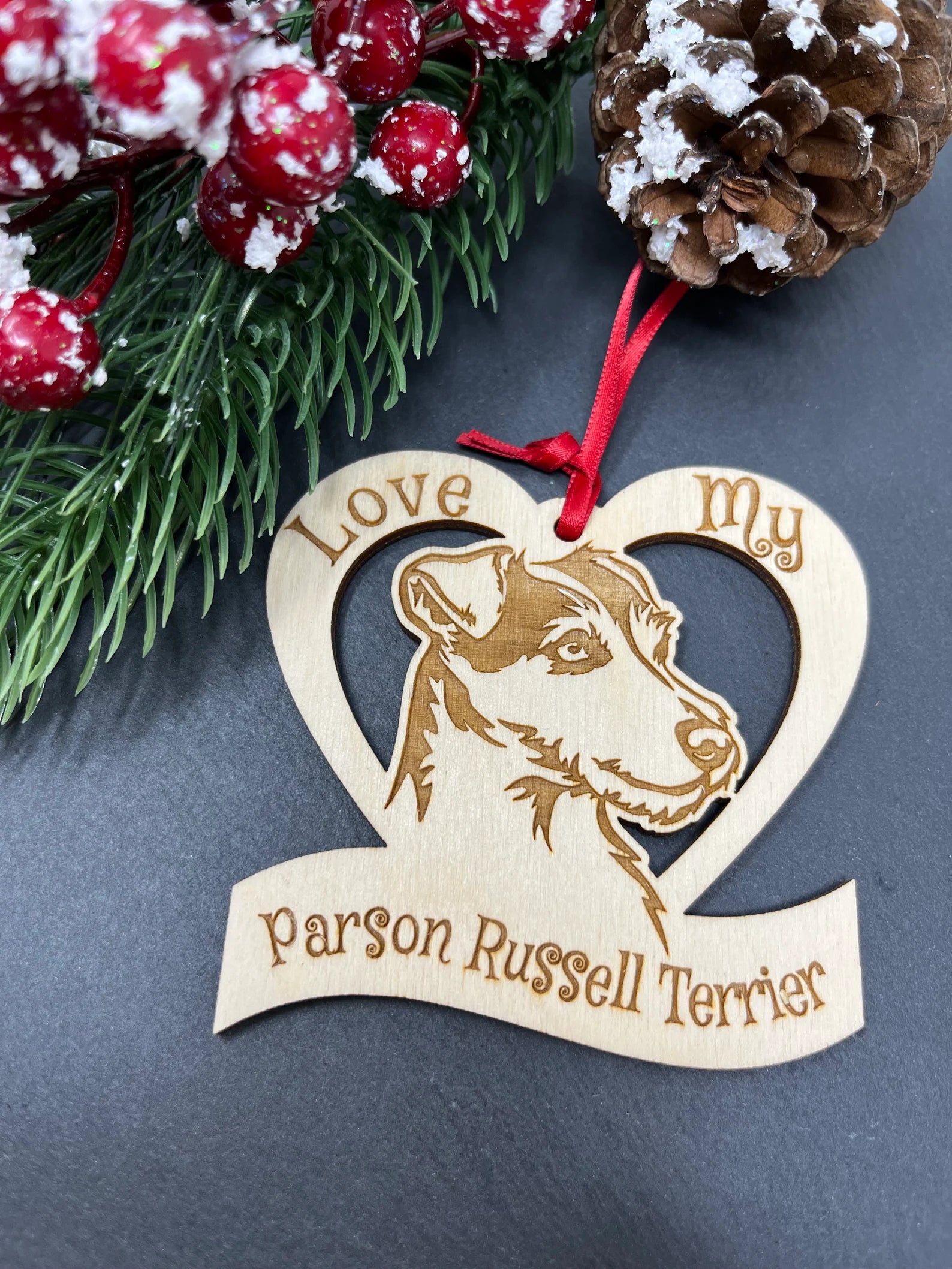 A beautifully laser engraved wooden ornament featuring a Parson Russell Terrier, perfect for Christmas decoration.