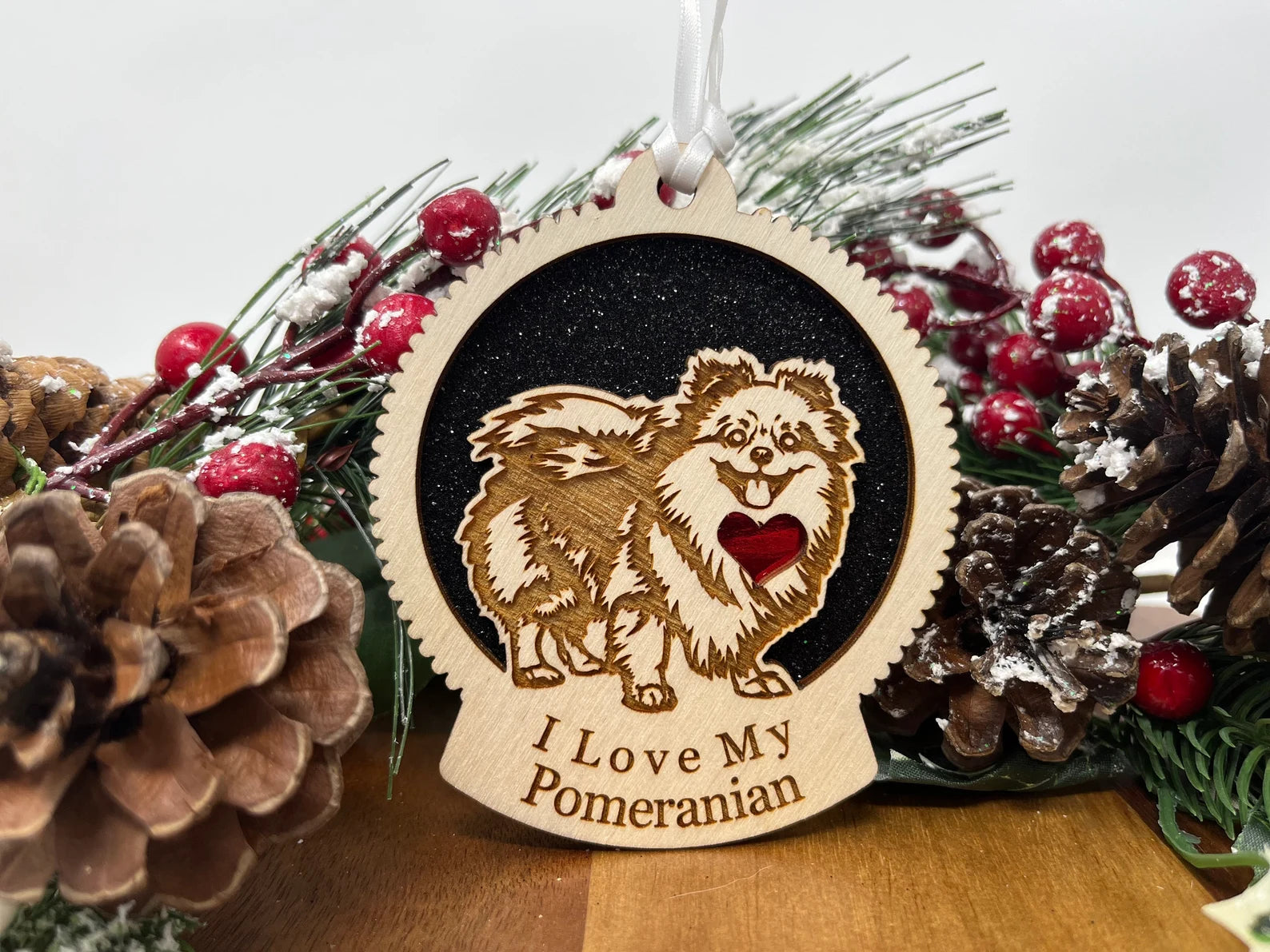 Laser cut wooden ornament featuring a Pomeranian silhouette, perfect for Christmas decoration.