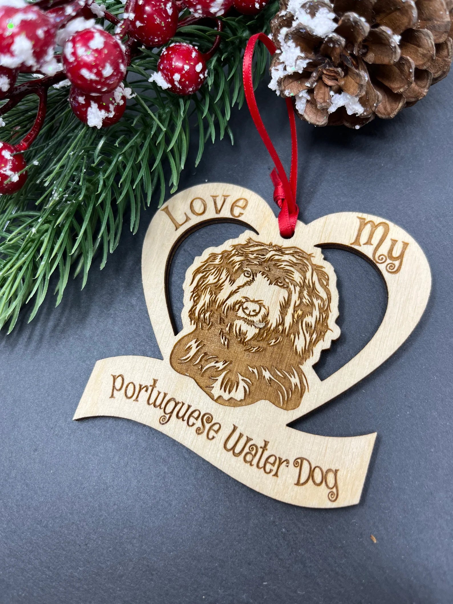 Laser engraved wooden ornament featuring a Portuguese Water Dog, perfect for Christmas decoration.