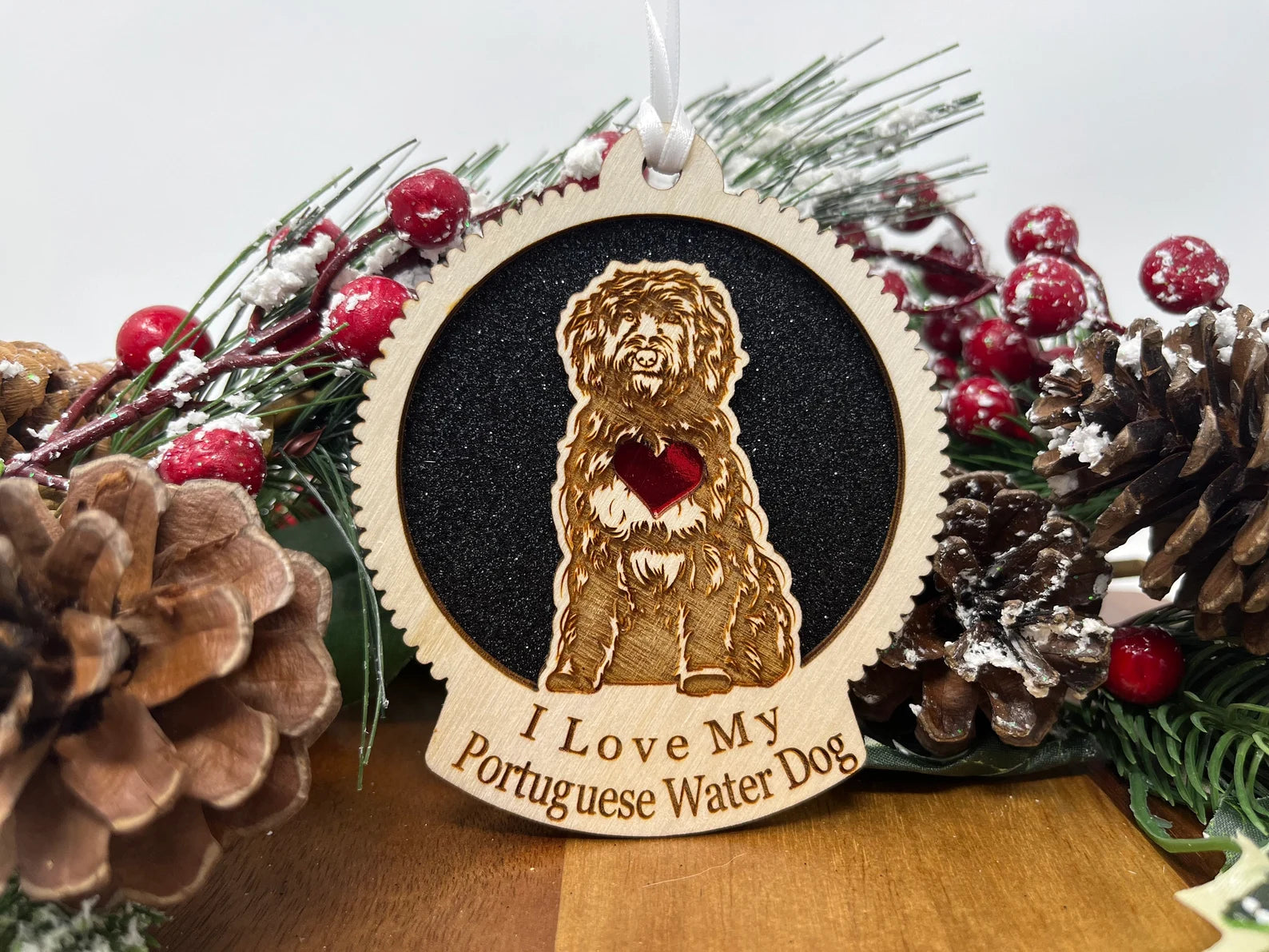 Laser cut wooden ornament featuring a Portuguese Water Dog silhouette, perfect for Christmas decoration.