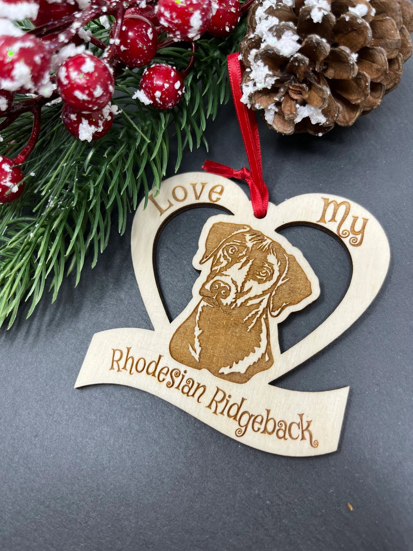 Laser engraved wooden ornament featuring a Rhodesian Ridgeback, perfect for Christmas decoration.