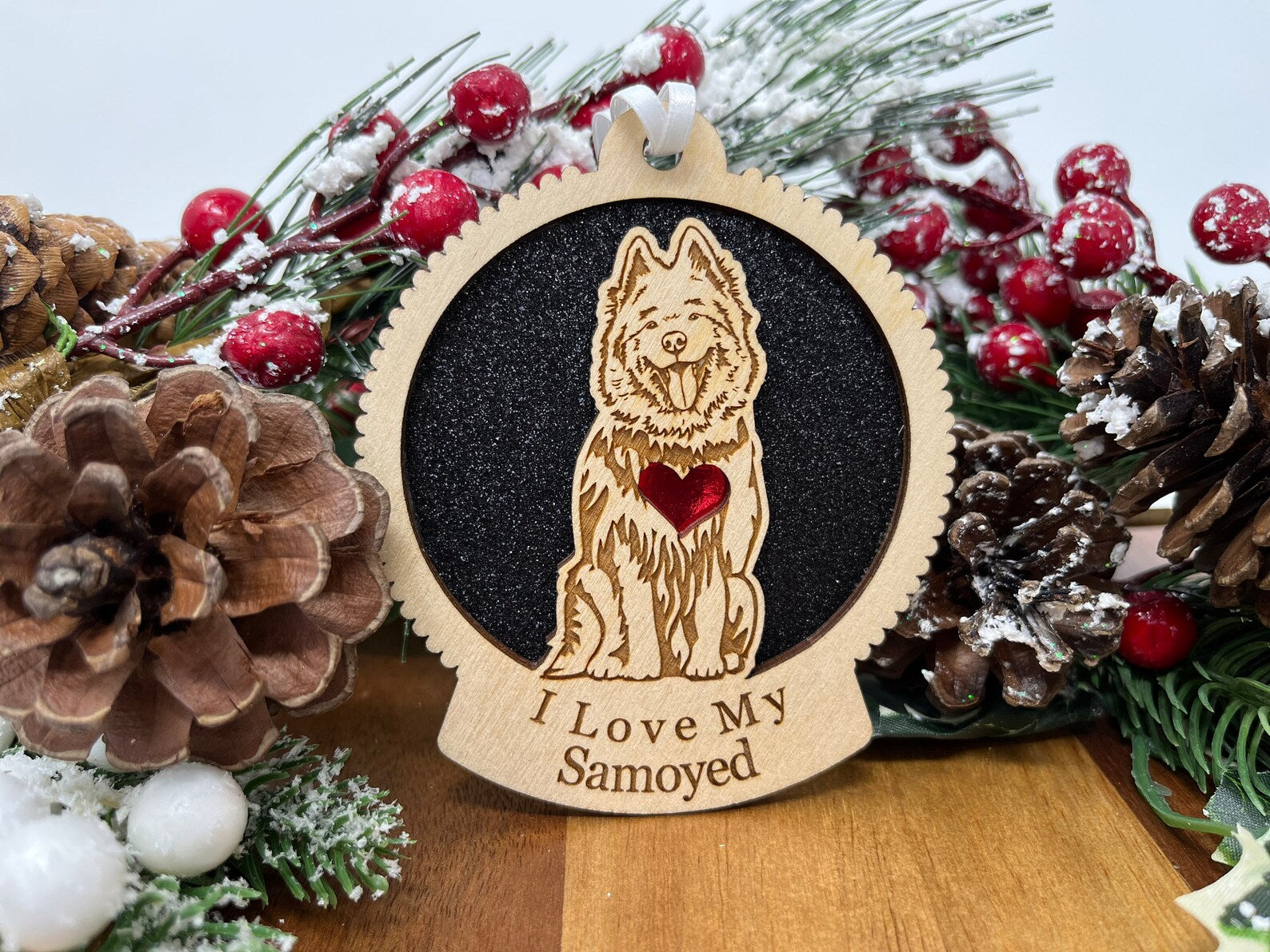 A beautifully crafted laser-cut wooden ornament featuring a Samoyed silhouette, perfect for Christmas decoration.