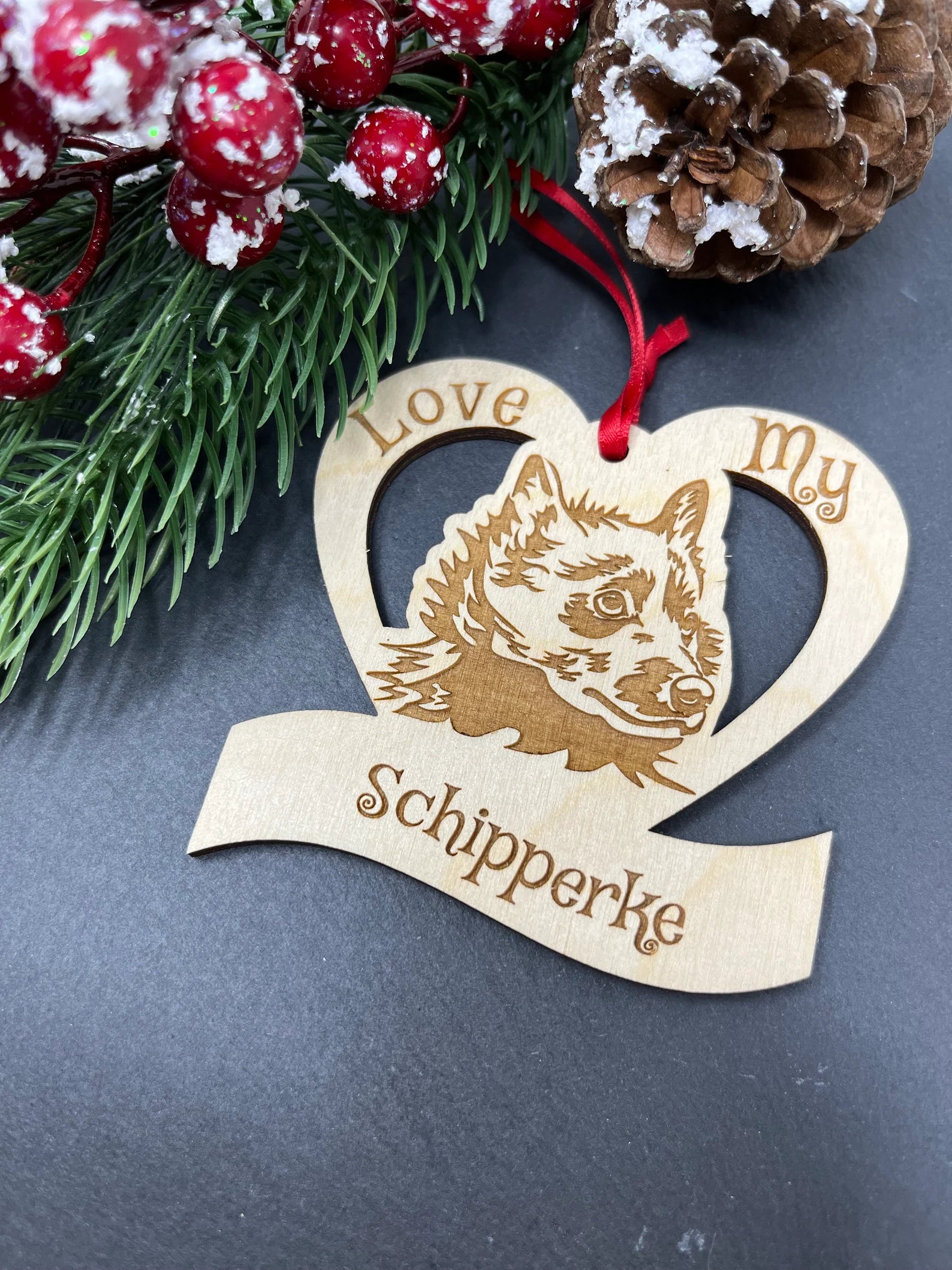 Beautiful laser engraved wooden ornament featuring a Schipperke, perfect for Christmas decoration.