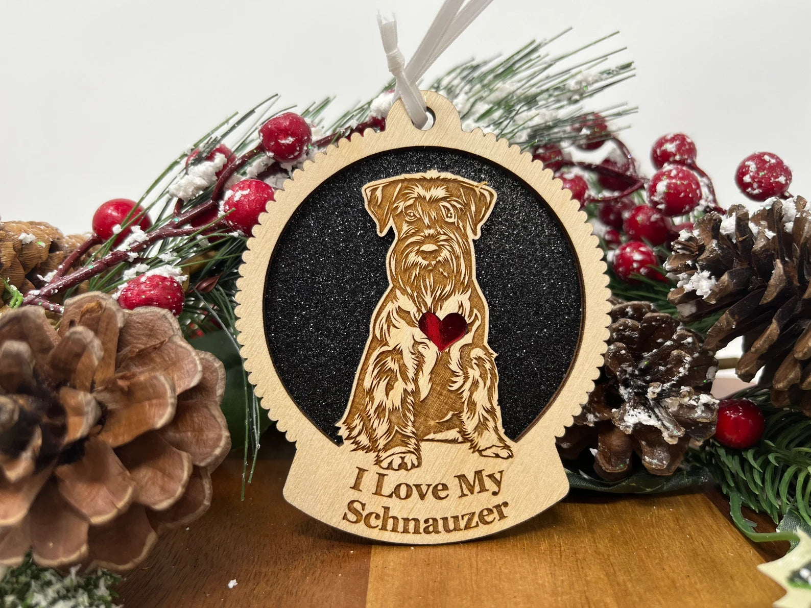 A beautifully crafted wooden ornament featuring a laser-cut silhouette of a Schnauzer, perfect for holiday decor.