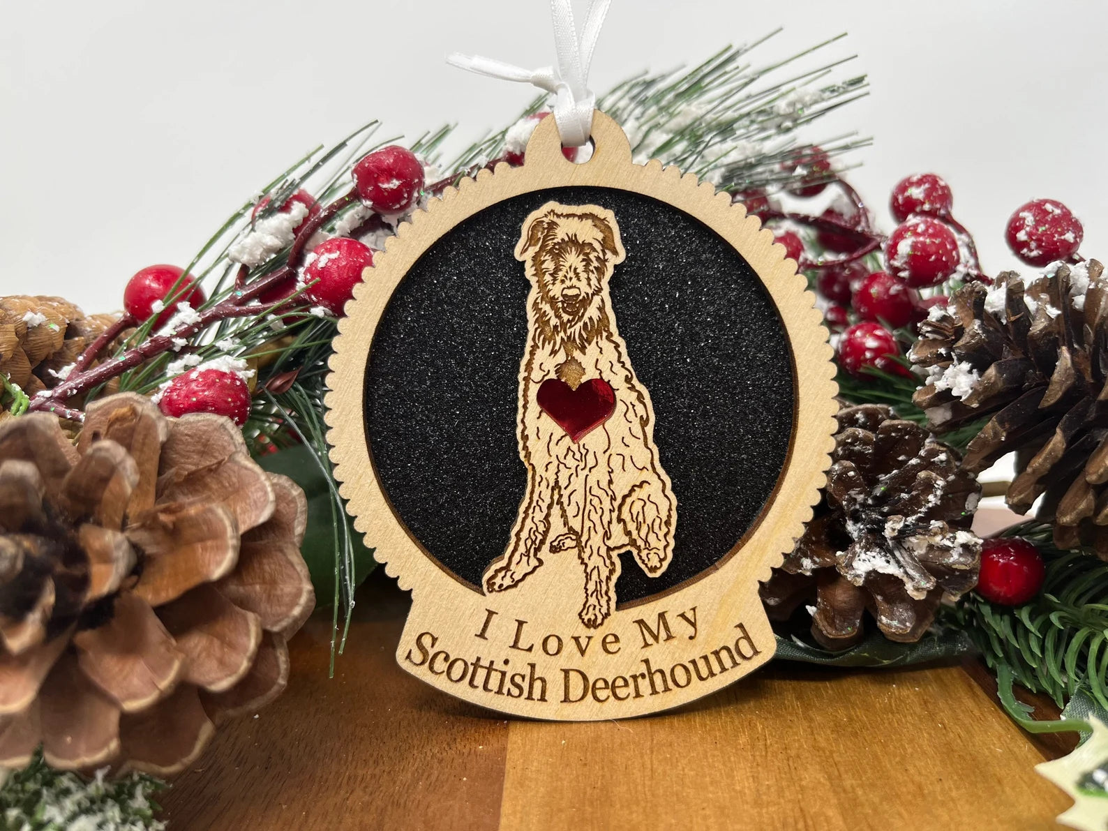 A beautifully crafted laser-cut wooden ornament featuring a Scottish Deerhound silhouette, perfect for Christmas decoration.