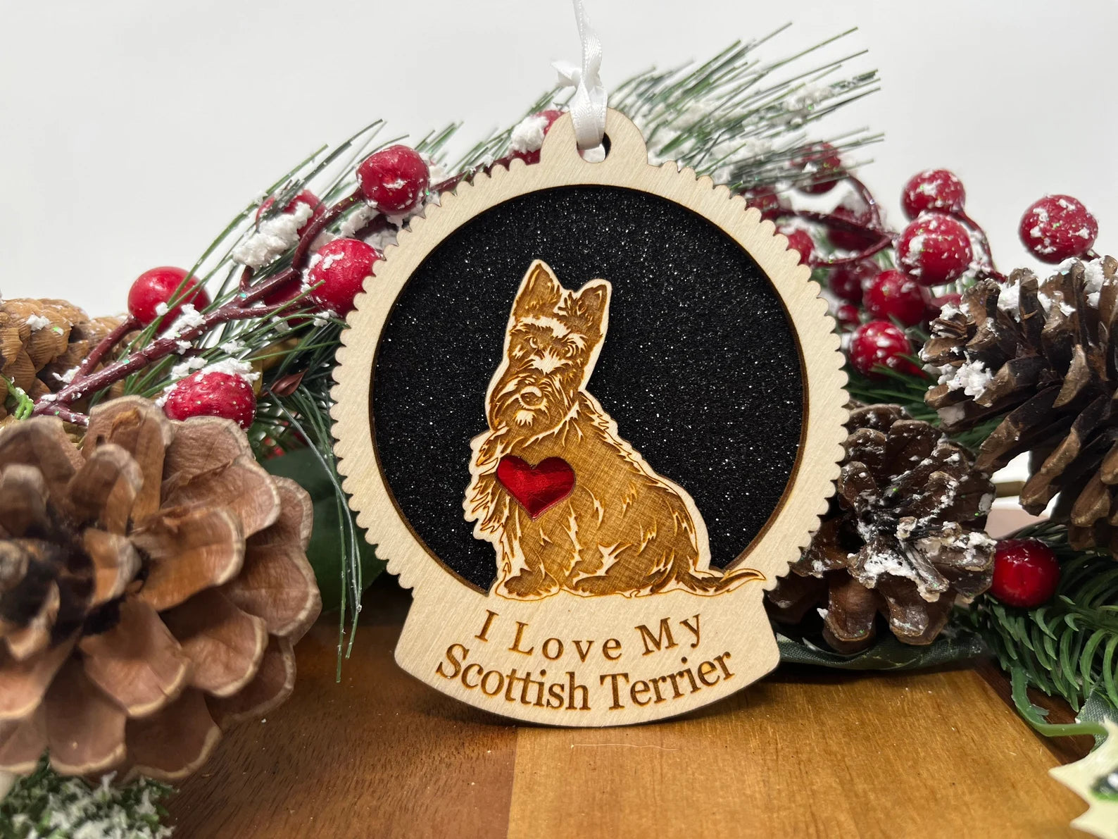 A beautifully crafted wooden ornament featuring a Scottish Terrier silhouette, perfect for Christmas decoration.