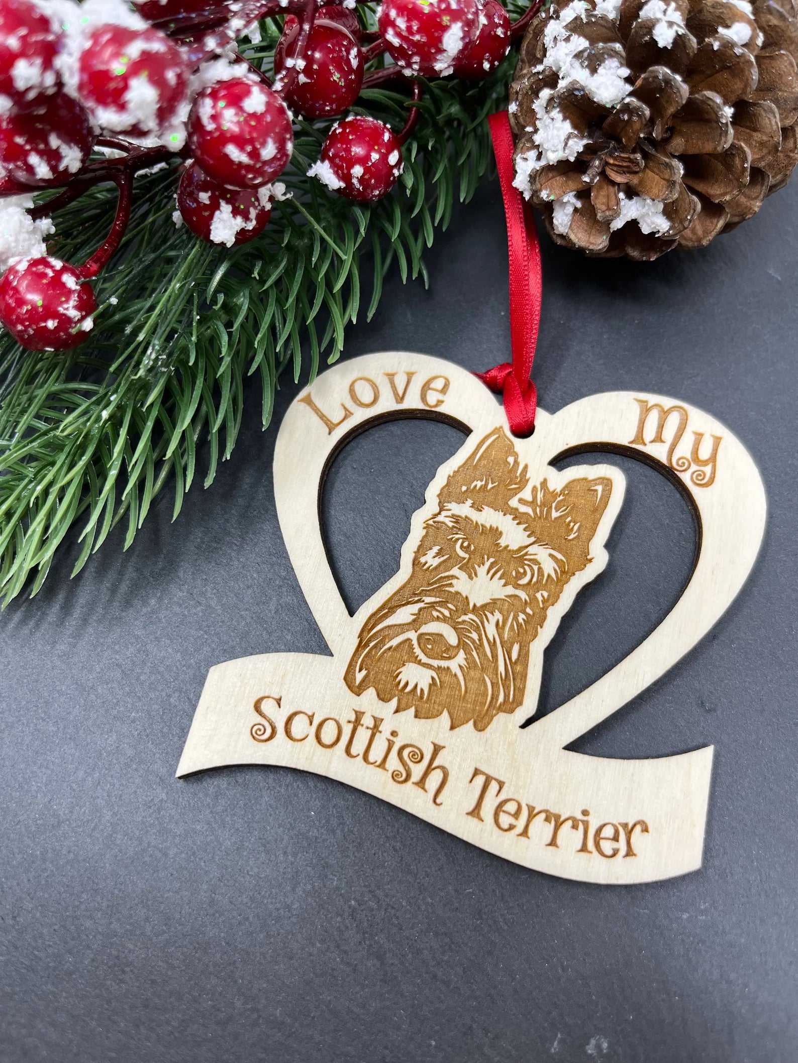 A beautifully laser engraved wooden ornament featuring a Scottish Terrier, perfect for Christmas decoration.