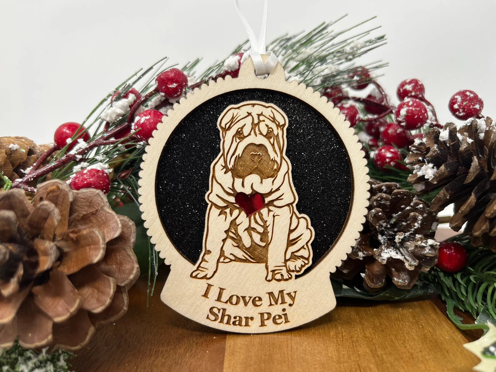 A beautifully crafted wooden ornament featuring a laser-cut silhouette of a Shar Pei, perfect for holiday decor.