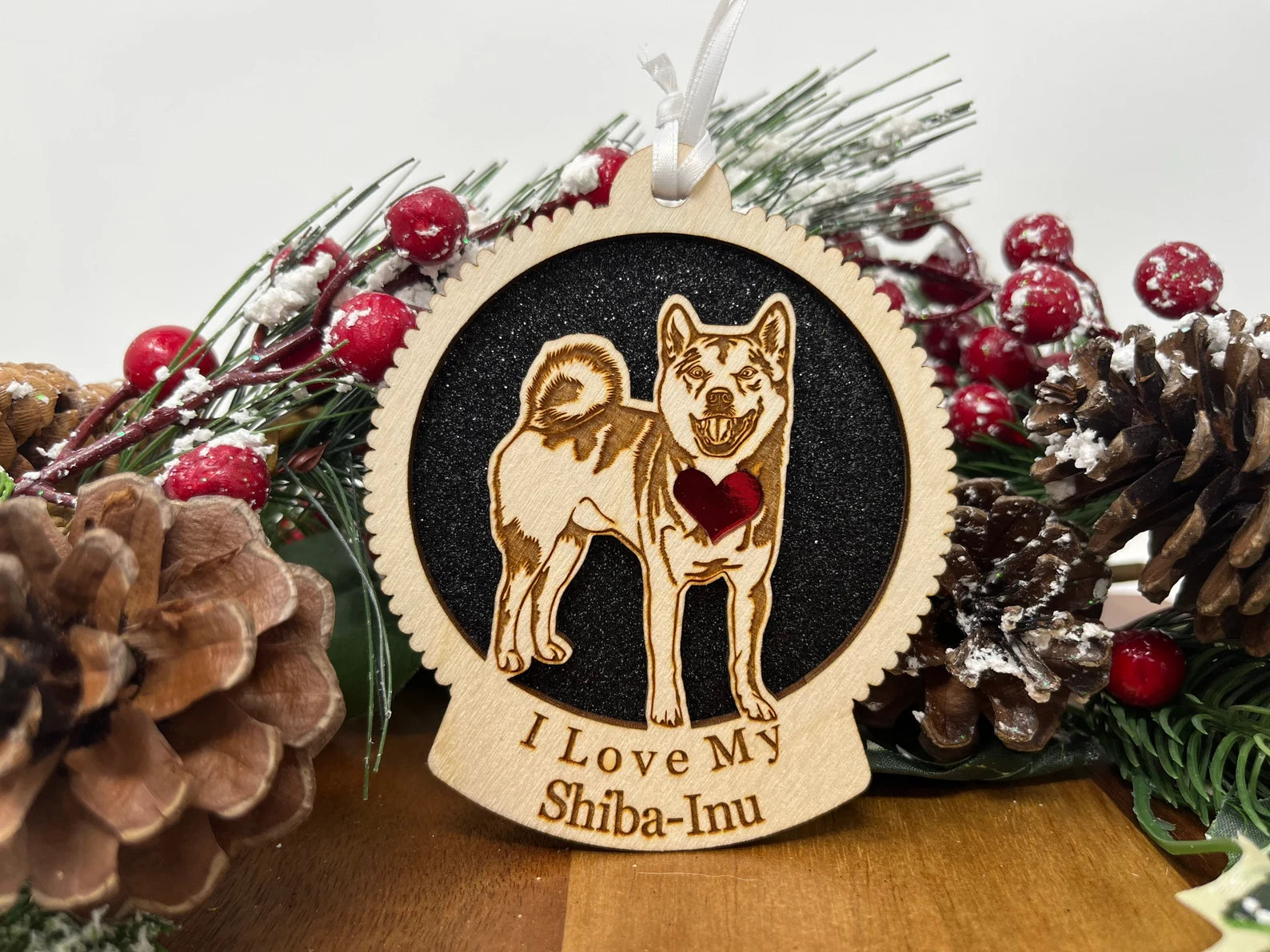 A beautifully crafted laser-cut wooden ornament featuring a Shiba Inu silhouette, perfect for Christmas decor.