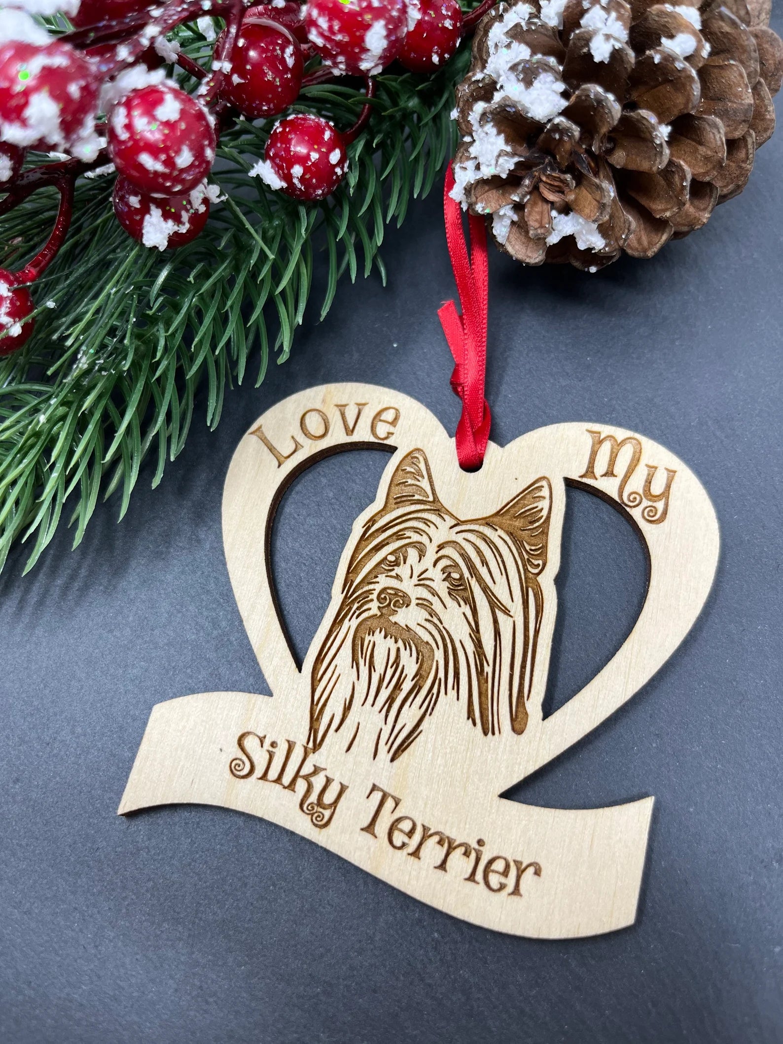 Love My Silky Terrier ornament made of laser engraved Baltic Birch wood, featuring a detailed design and attached ribbon for hanging.