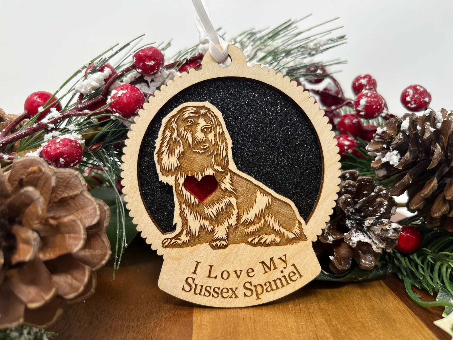 A beautifully crafted laser-cut wooden ornament featuring a Sussex Spaniel silhouette, perfect for Christmas decoration.