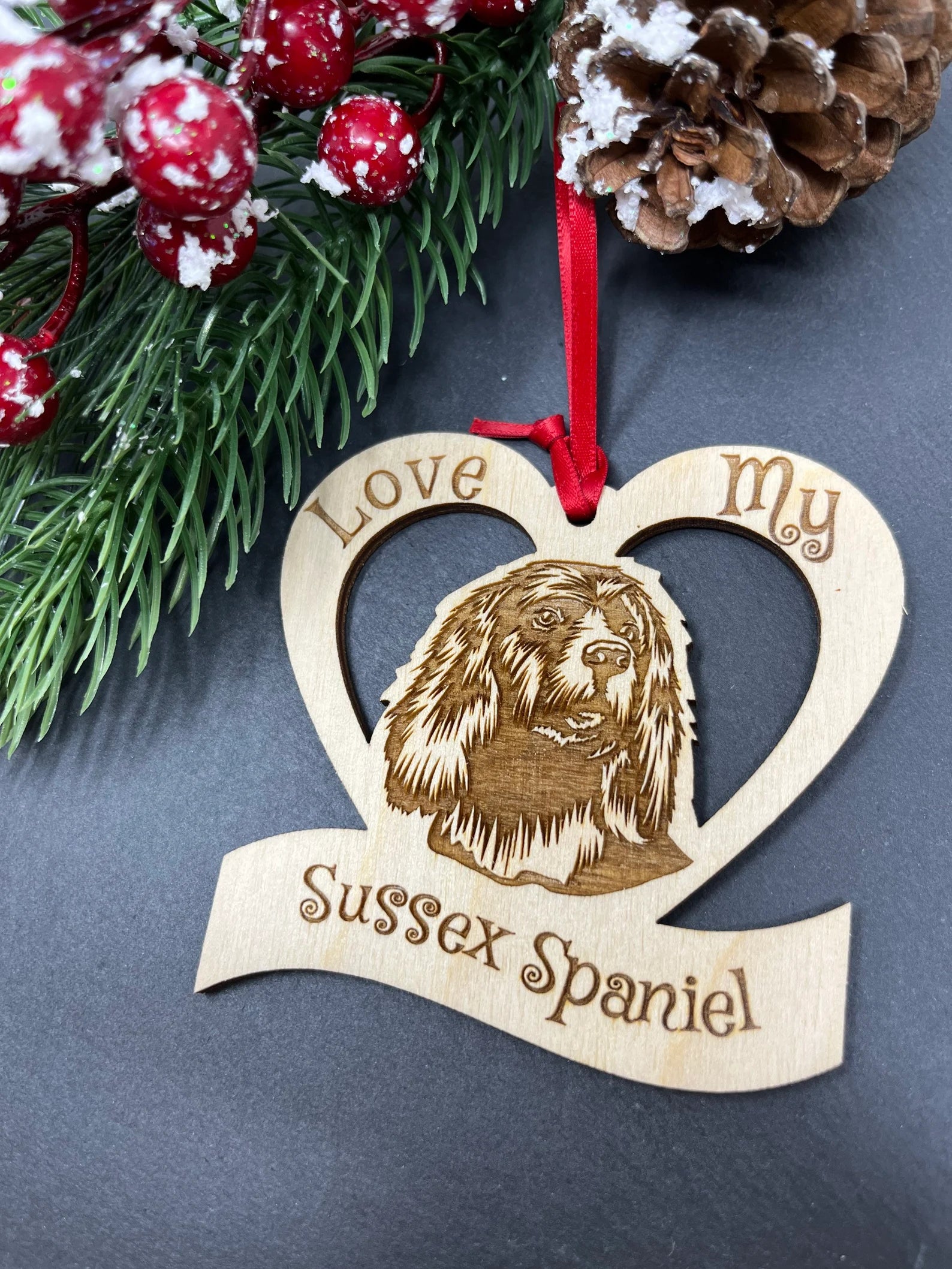 Laser engraved wooden ornament featuring a Sussex Spaniel, perfect for Christmas decoration.