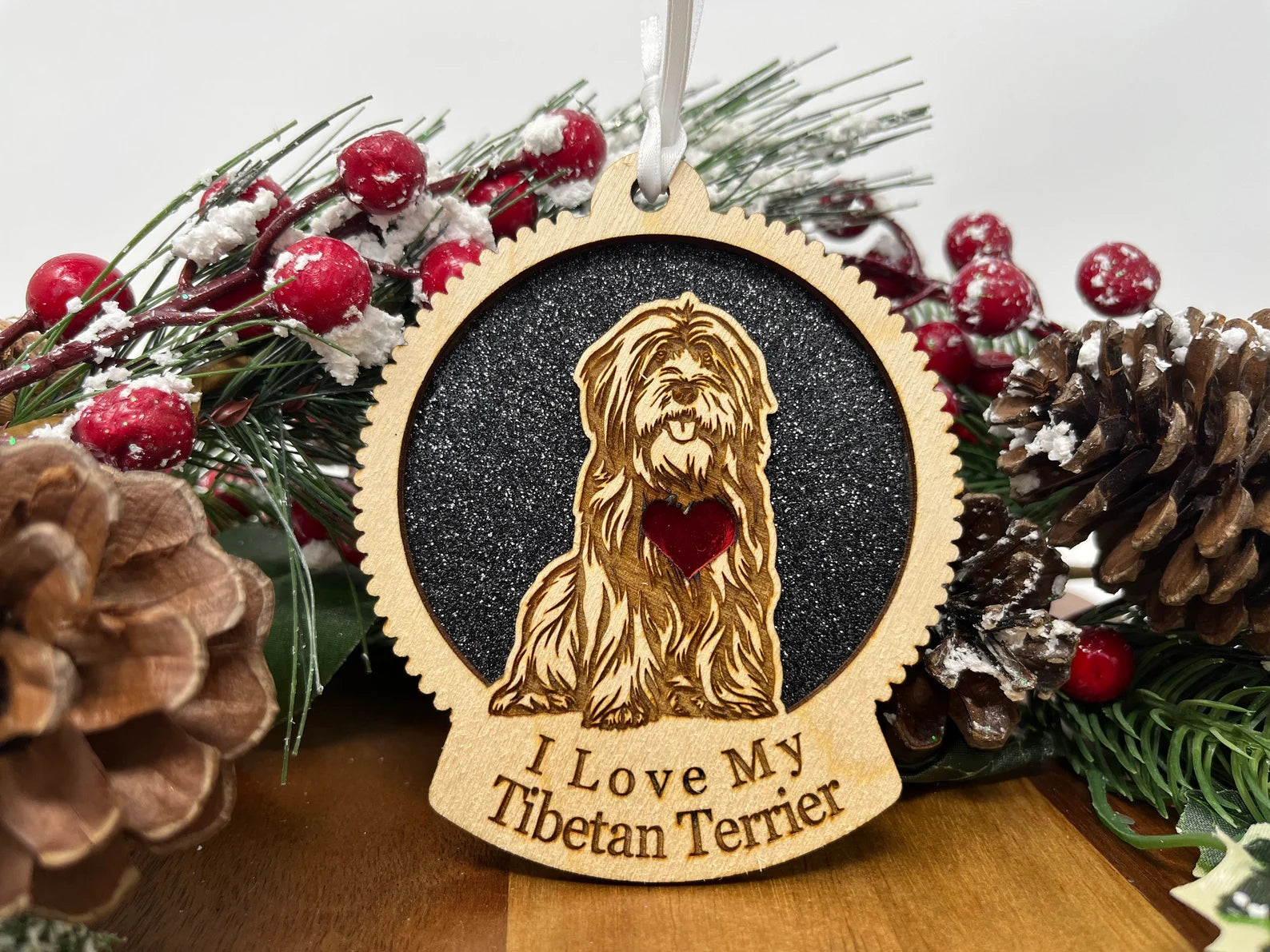 A beautifully laser-cut wooden ornament featuring a Tibetan Terrier silhouette, perfect for Christmas decoration.