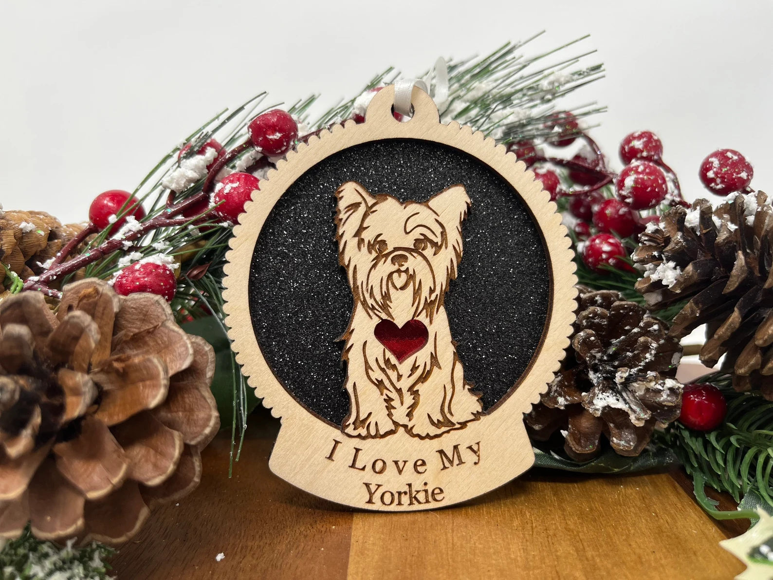 Beautiful laser-cut wooden ornament featuring a Yorkie silhouette, perfect for Christmas decoration.